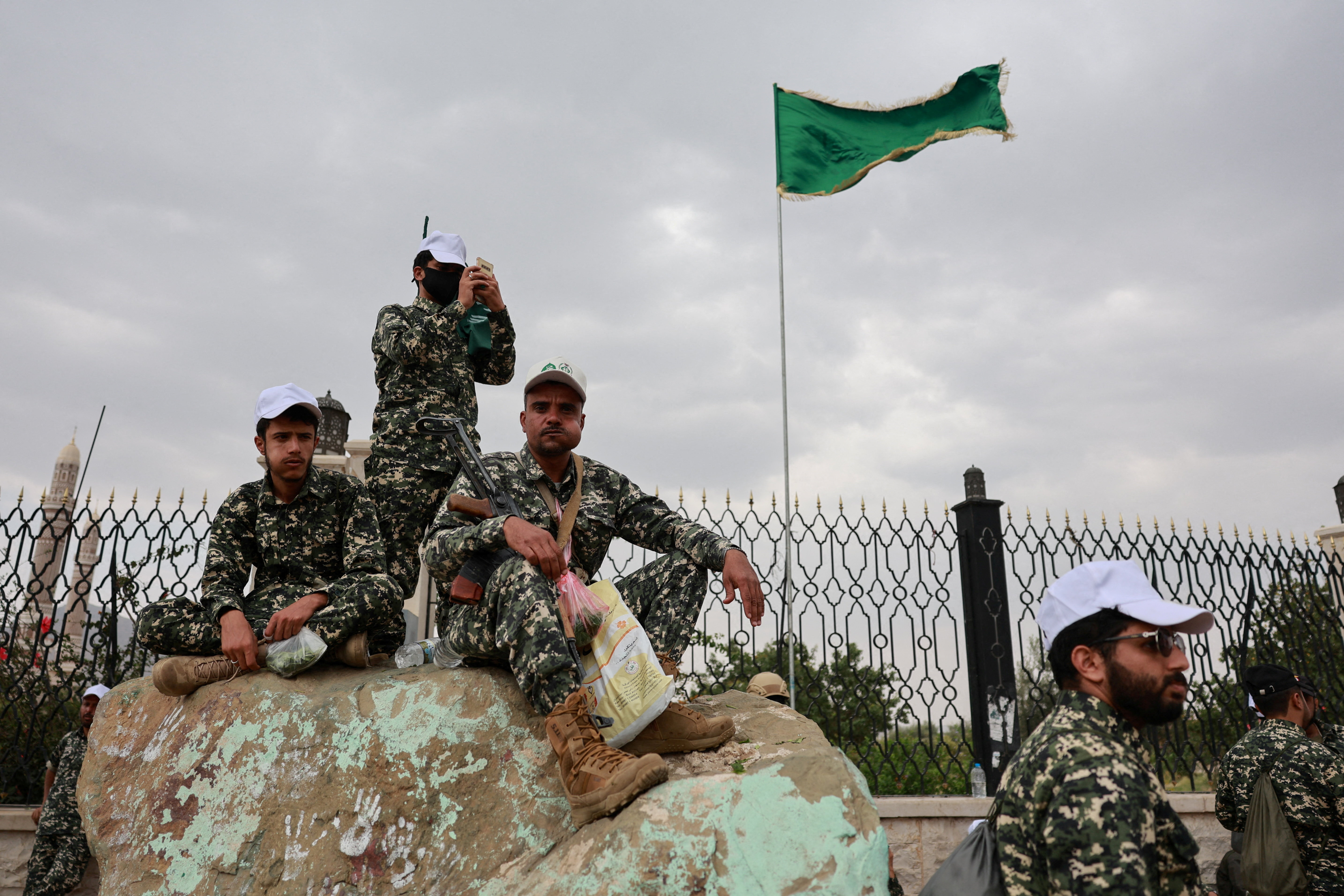 Members of Houthi security forces sit on a rock at the site of a rally held to commemorate Mawlid, marking the anniversary of Prophet Muhammad's birthday, in Sanaa, Yemen, August 25, 2026. REUTERS/Khaled Abdullah TPX IMAGES OF THE DAY