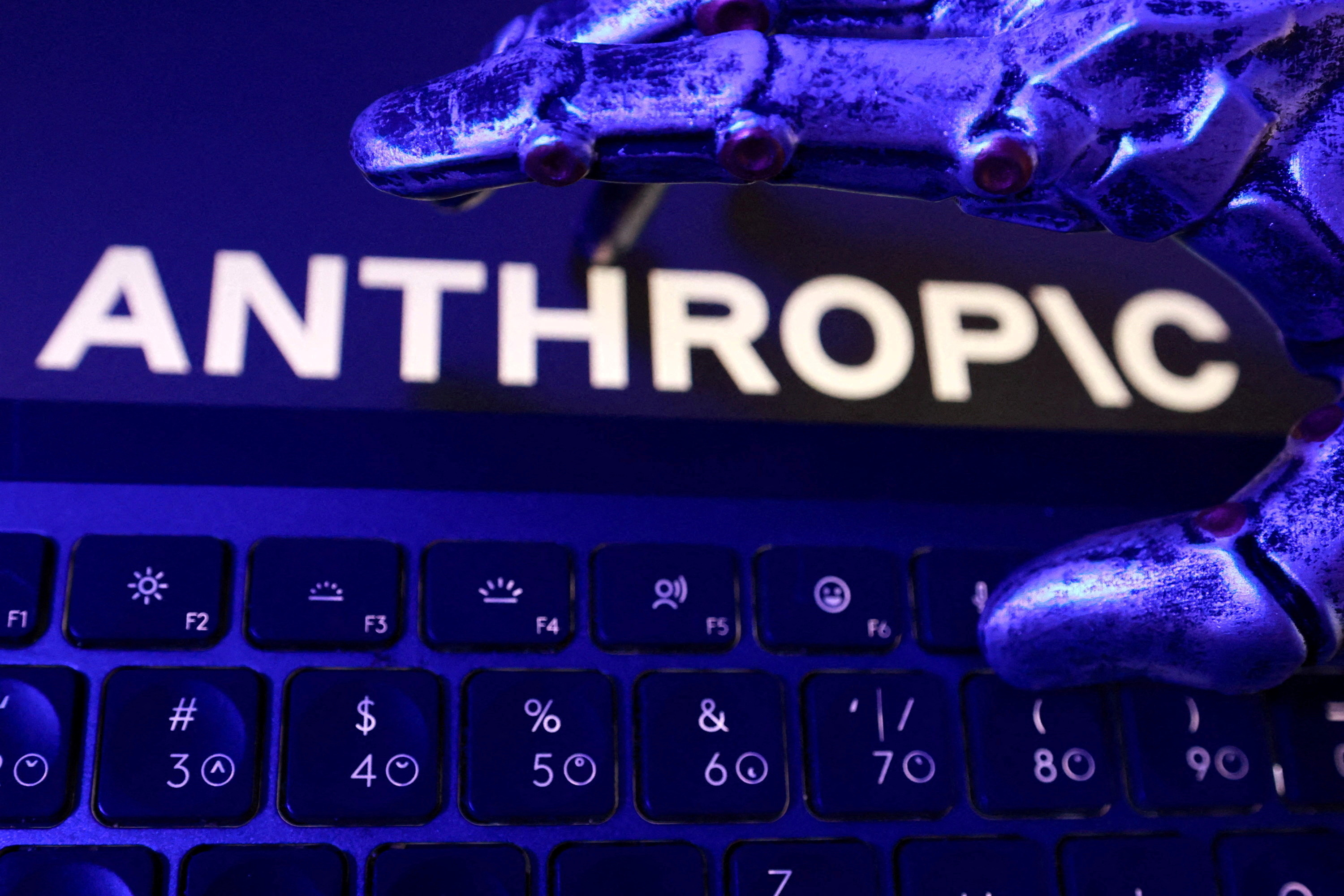 Anthropic logo, a keyboard, and a robotic hand in an illustration.