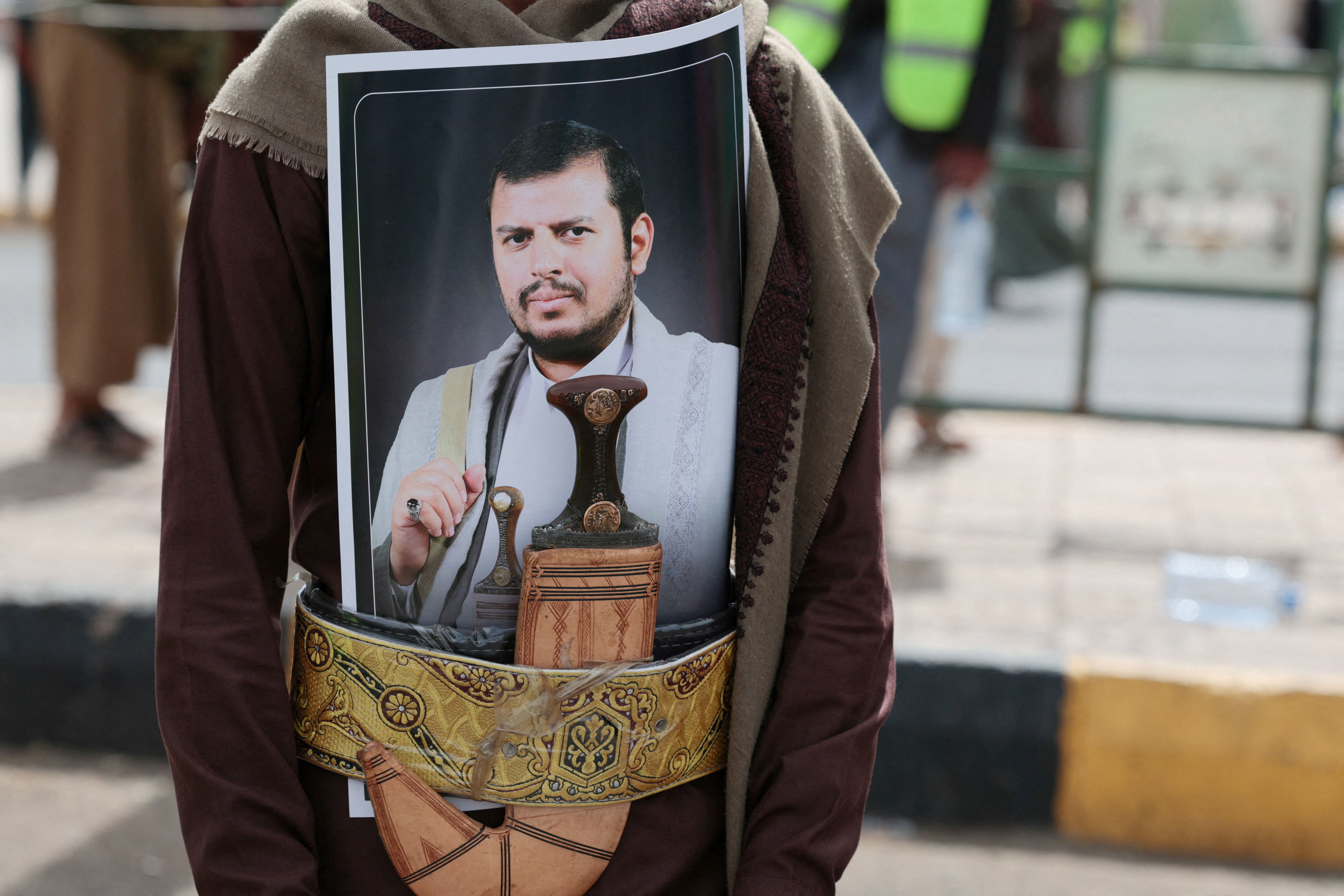 FILE PHOTO: A Houthi supporter sports a poster of the group's leader, Abdul-Malik al-Houthi, in his dagger's belt, during a rally against the Saudi-led coalition's restrictions on Houthi-controlled areas, which the group describes as a blockade, in Sanaa, Yemen, July 17, 2026. REUTERS/Khaled Abdullah/File Photo