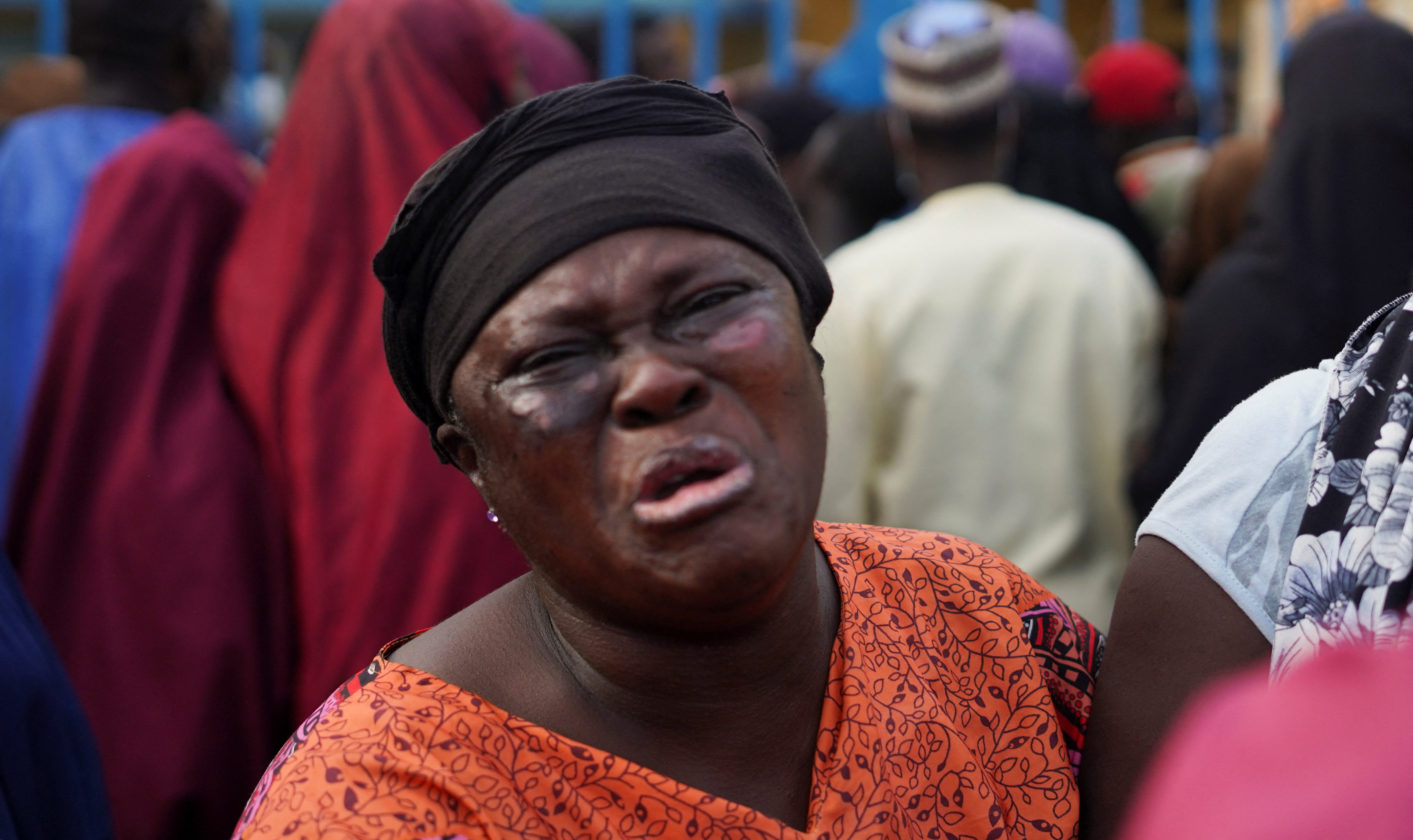 A family member of illegal mining suspects who died while in detention weep at Minna General Hospital, in Minna, Niger State, Nigeria
