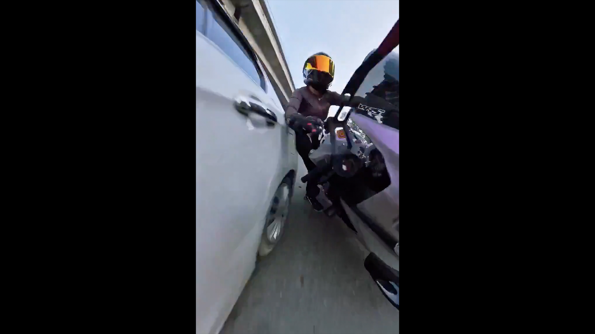 Indian police have launched a probe after a woman biker shared video of a car ramming her motorcycle.