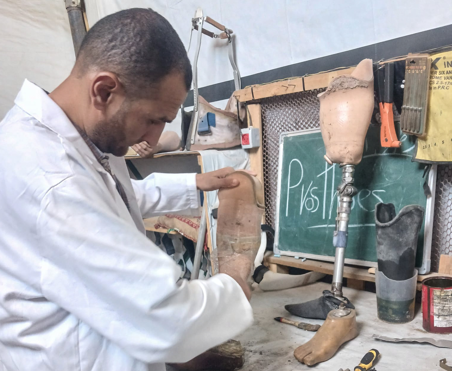 Dr Mohammed Al-Khalidi, a specialist in prosthetics and orthotics, continues to work from inside a tent after his private clinic was destroyed during the war October 6, 2026 [Iyad Al-Qatrawi/Al Jazeera]