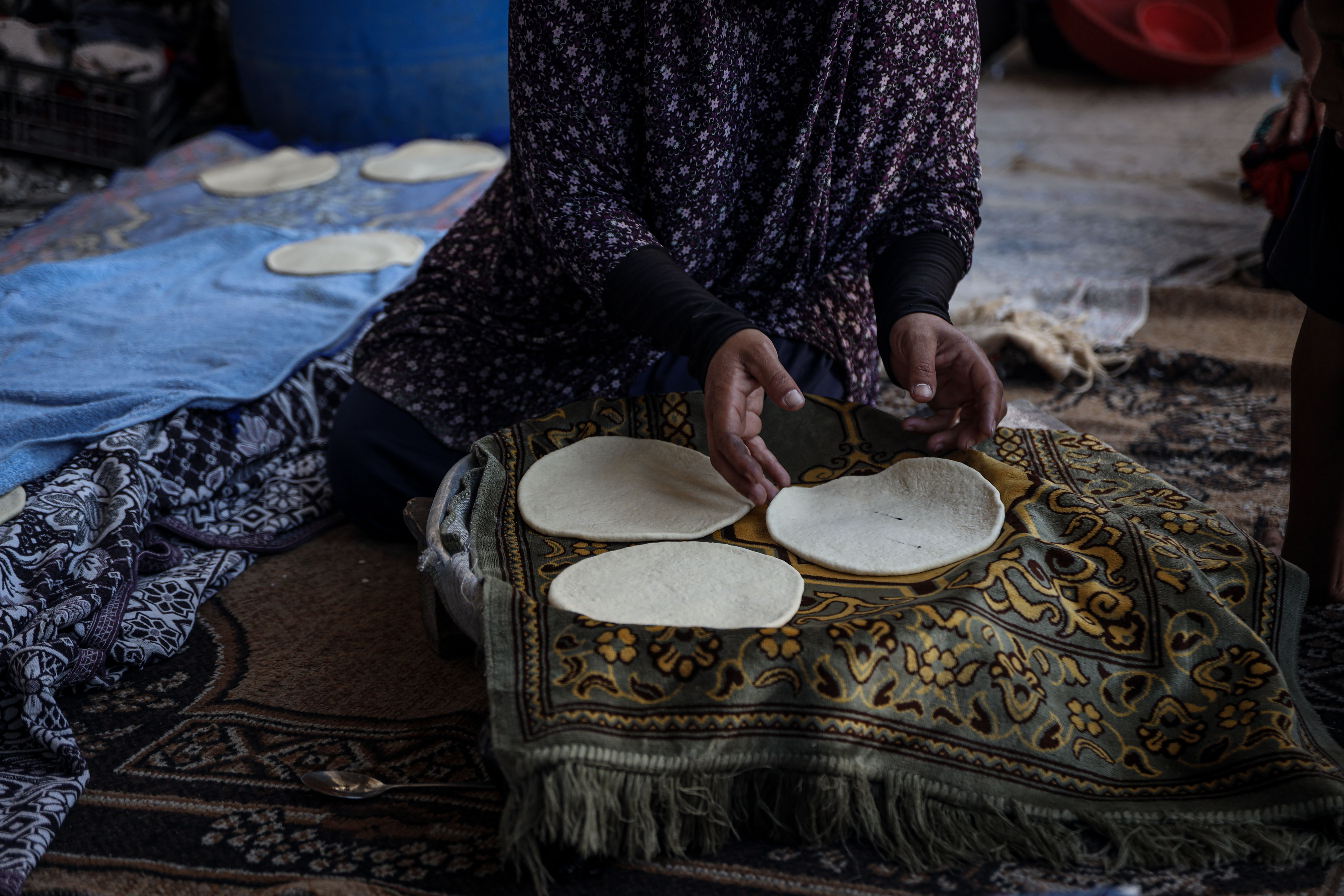 Displaced Palestinian families in Gaza fear the impact of rising food prices and aid cuts on their children’s health and nutrition. [Abdelhakim Abu Riash/Al Jazeera]