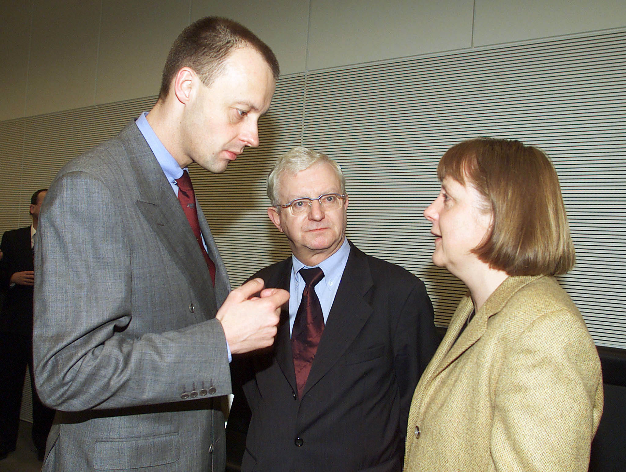 Designated German Christian Democratic Party (CDU) Parliamentary Floor Leader Friedrich Merz (L), Party Secretary General Angela Maerkel (R) and Member of Parliament Rudolf Seiters talk before a meeting of the CDU parliamentary group in the Berlin Reichstag, February 18. Merz is announced to become the new leader of the CDU parliamentary group, replacing Wolfgang Schaeuble who quit both as leader of the CDU Parliamentary group and from the Christian Democratic Party (CDU) chairmanship over his handling of a massive funding scandal.RKR
