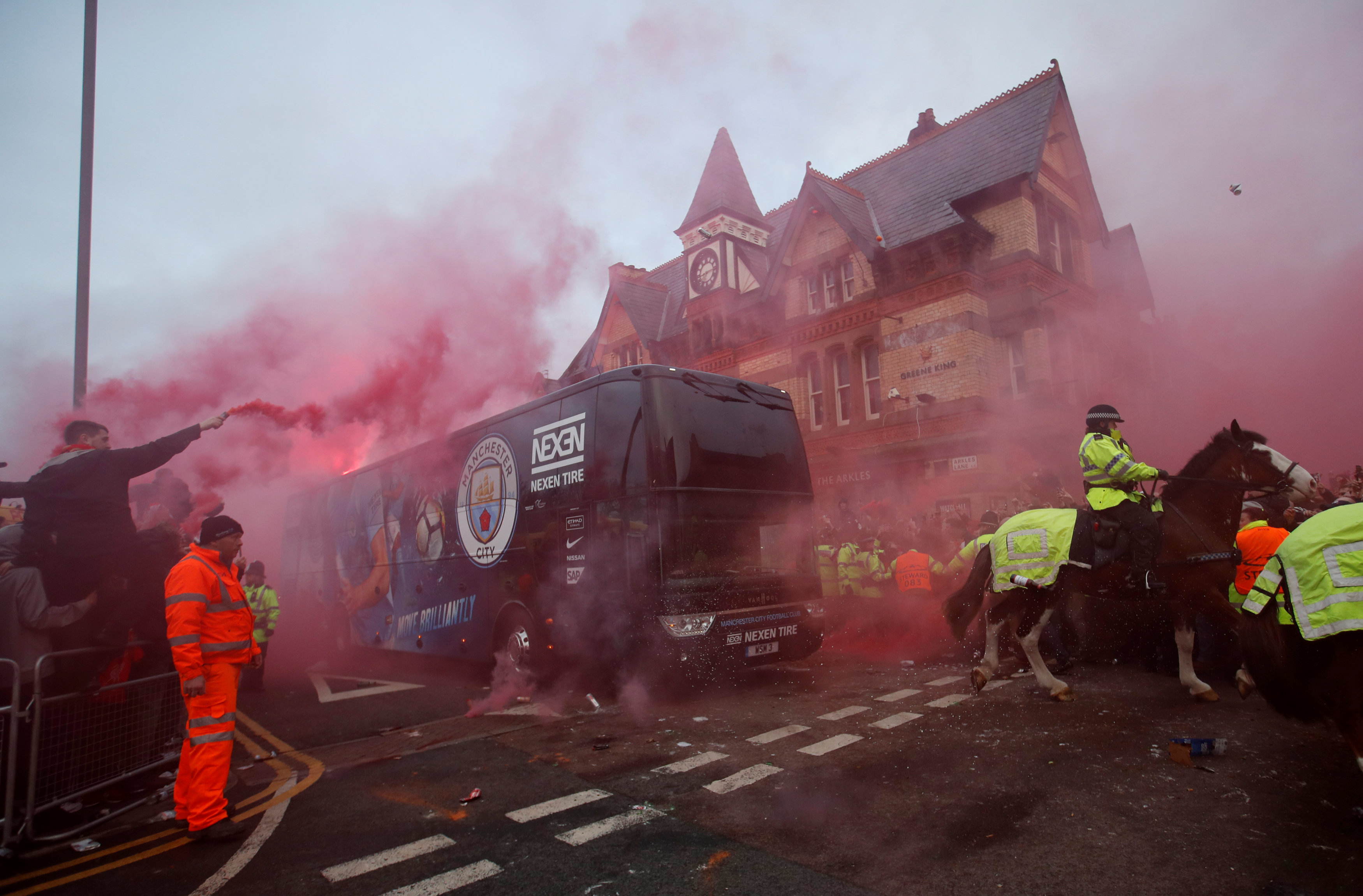 Soccer Football - Champions League Quarter Final First Leg - Liverpool vs Manchester City - Anfield, Liverpool, Britain - April 4, 2018 Liverpool fans set off flares and throw missiles at the Manchester City team bus outside the stadium before the match Action Images via Reuters/Carl Recine
