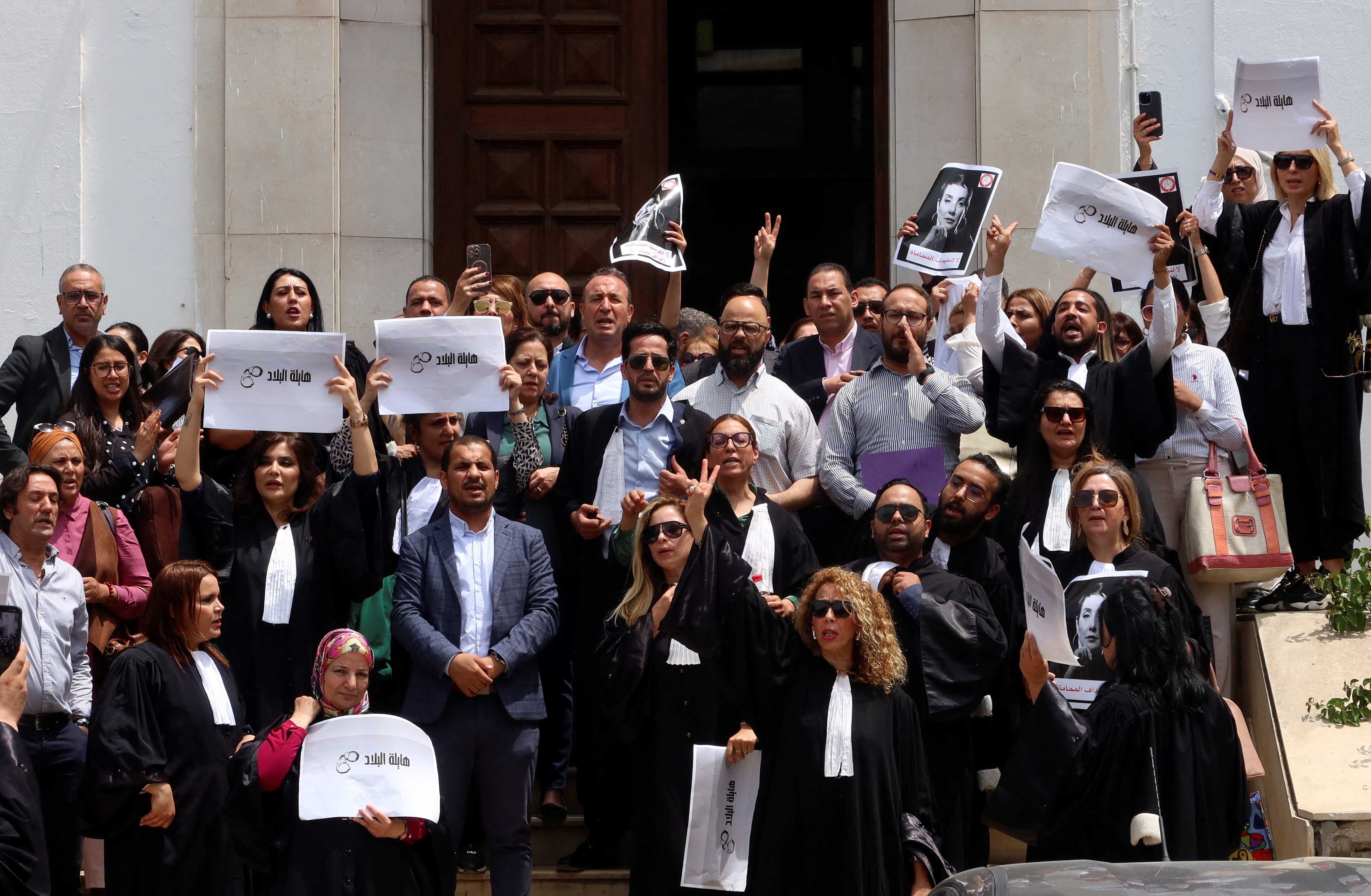 Lawyers carry banners during a praotest against the arrest of Sonia Dahmani, a prominent lawyer critical of the president, outside the Palace of Justice building in Tunis, Tunisia May 13, 2024. REUTERS/Jihed Abidellaoui