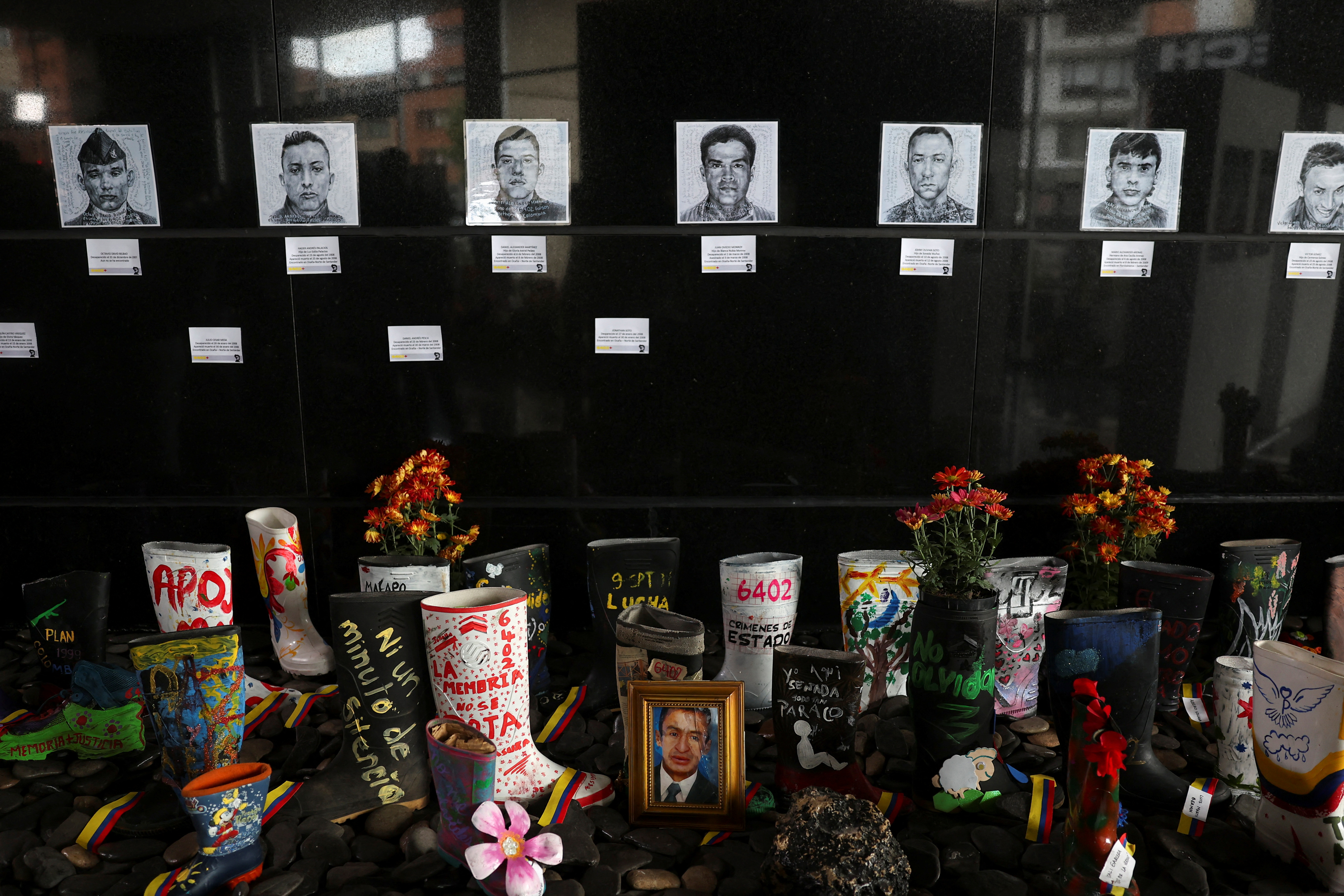 Decorated rubber boots are displayed during a tribute made by the Special Jurisdiction for Peace (JEP) to the victims of extrajudicial executions carried out by the Colombian army, in Bogota, Colombia November 28, 2024. REUTERS/Luisa Gonzalez