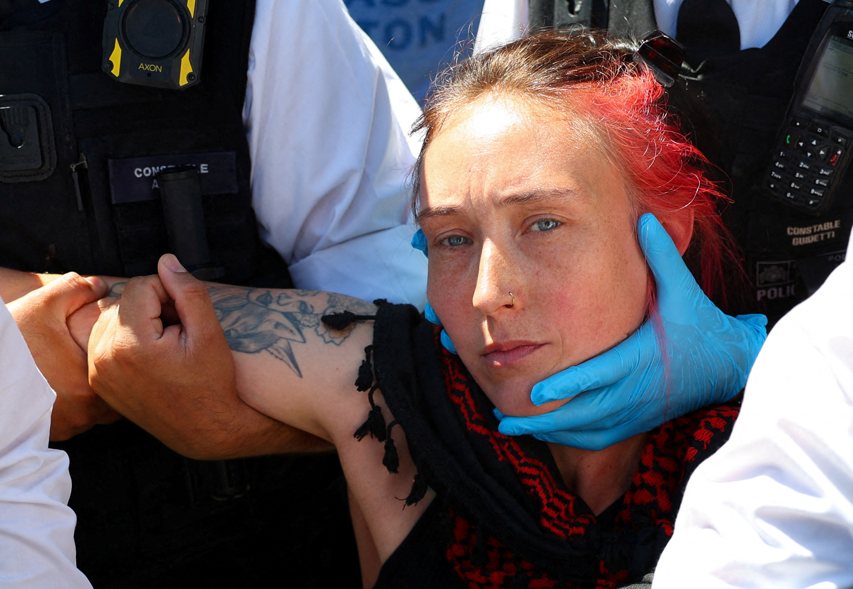 Police officers detain a protester during a demonstration calling for the de-proscription of the Palestine Action group, in Parliament Square, in London, Britain, July 12, 2025. REUTERS/Isabel Infantes TPX IMAGES OF THE DAY