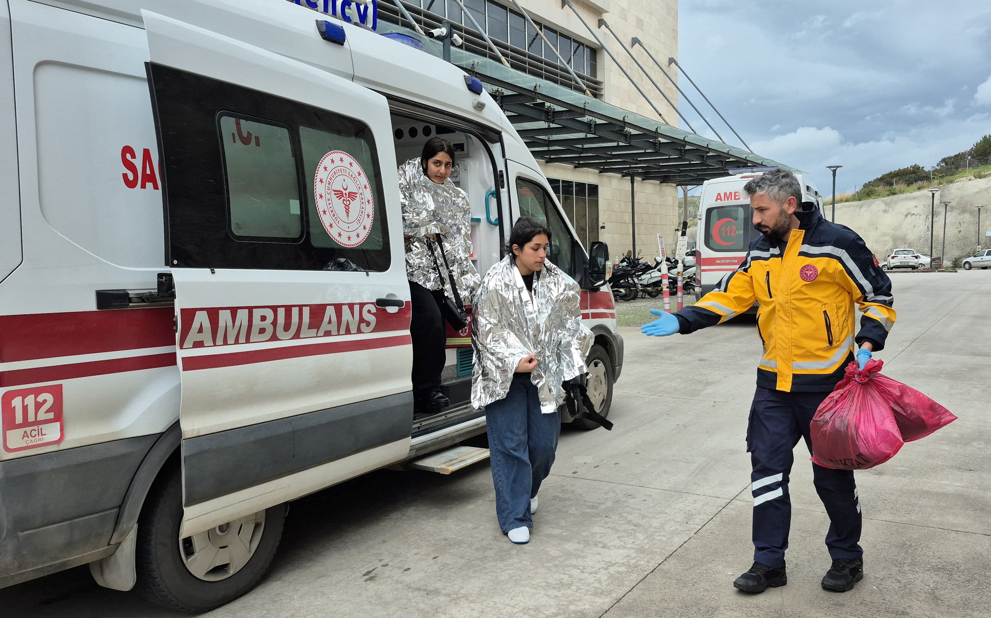 People rescued after a migrant boat sank off Turkey’s Aegean coast get out of an ambulance upon arrival at a hospital in Bodrum, Mugla province, Turkey, April 1, 2026. Picture taken with a mobile phone. REUTERS/Kenan Gurbuz