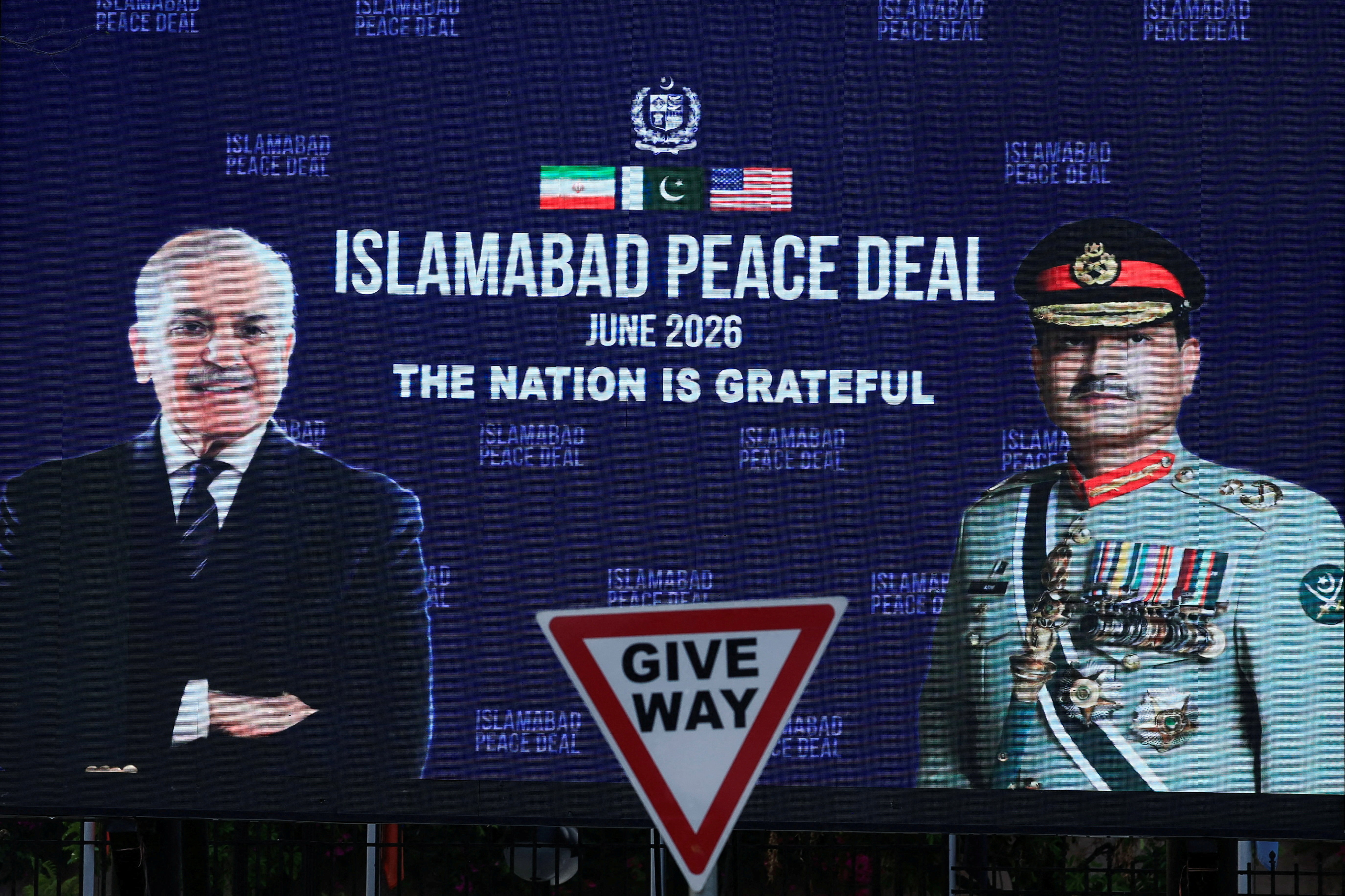 A roadside billboard displaying portraits of Pakistan's Chief of Army Staff Field Marshal Asim Munir and Prime Minister Shehbaz Sharif, following a deal between the U.S. and Iran, in Islamabad, Pakistan, June 16, 2026. REUTERS/Akhtar Soomro REFILE - CORRECTING INFORMATION FROM "GENERAL ASIM MUNIR" TO "FIELD MARSHAL ASIM MUNIR".
