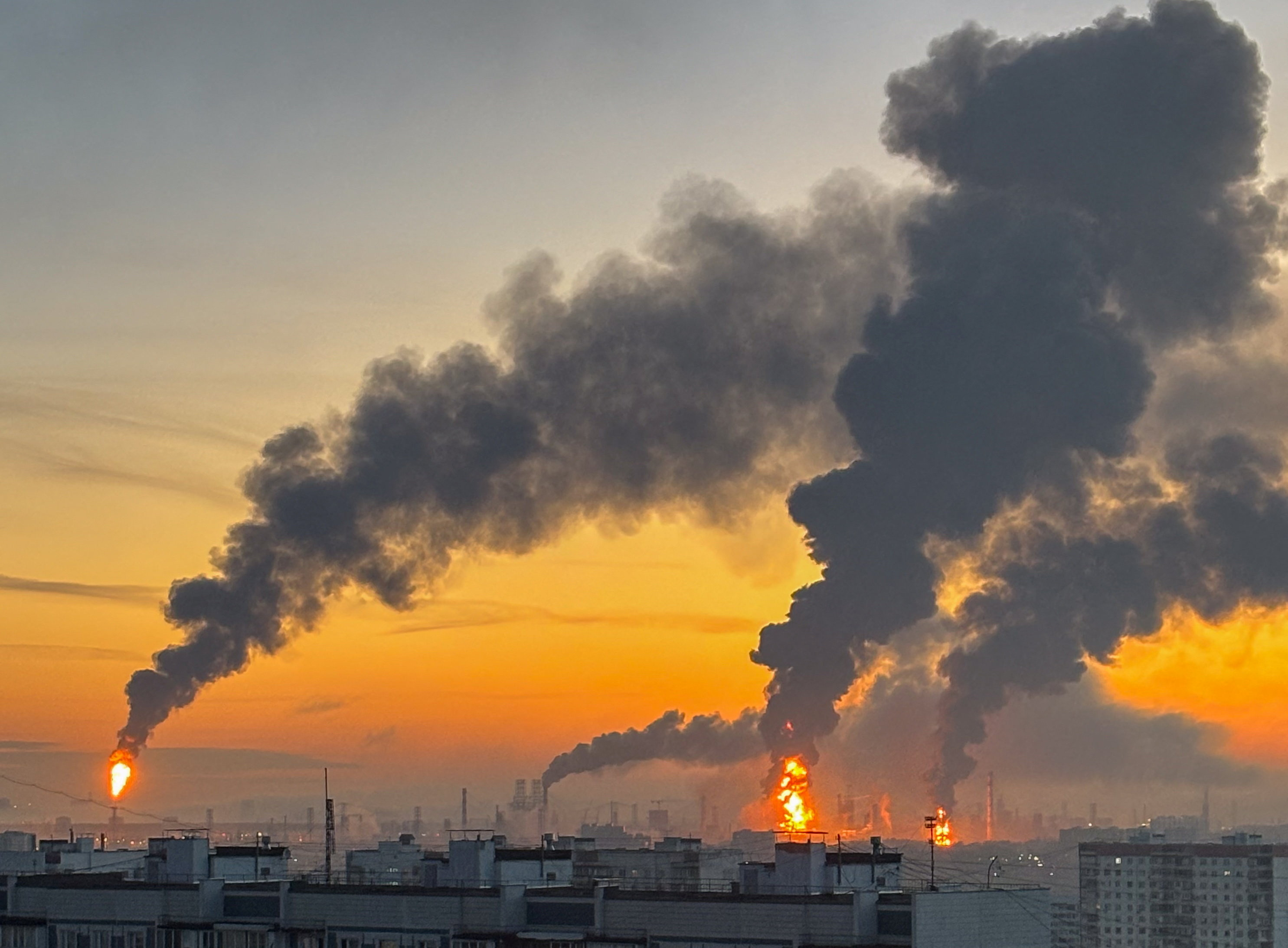 Plumes of smoke rise from fires (right) at an oil refinery following what the authorities say is a Ukrainian drone strike in the course of the Russia-Ukraine conflict, in Moscow,