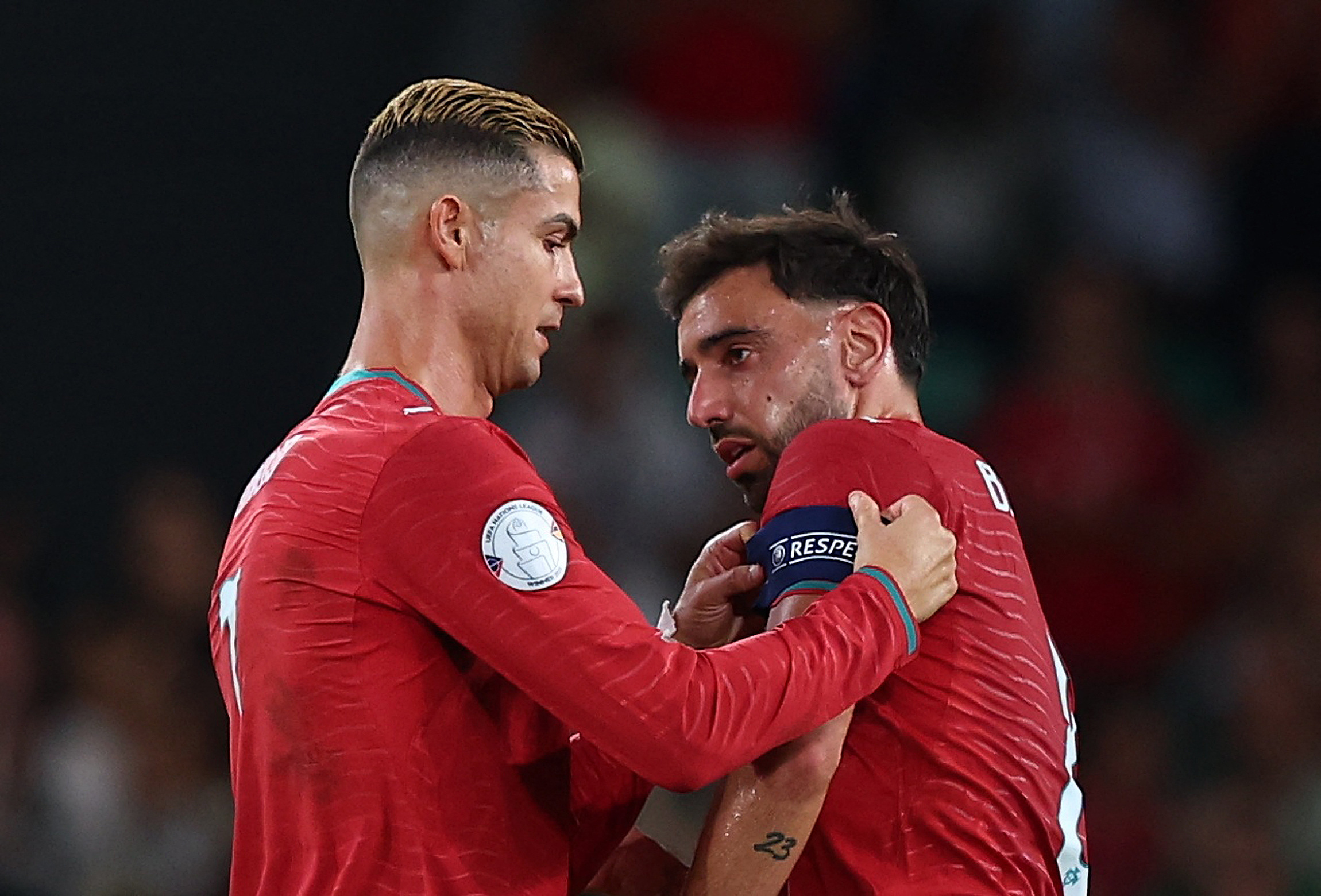 Portugal's Cristiano Ronaldo hands the captain's armband to Bruno Fernandes