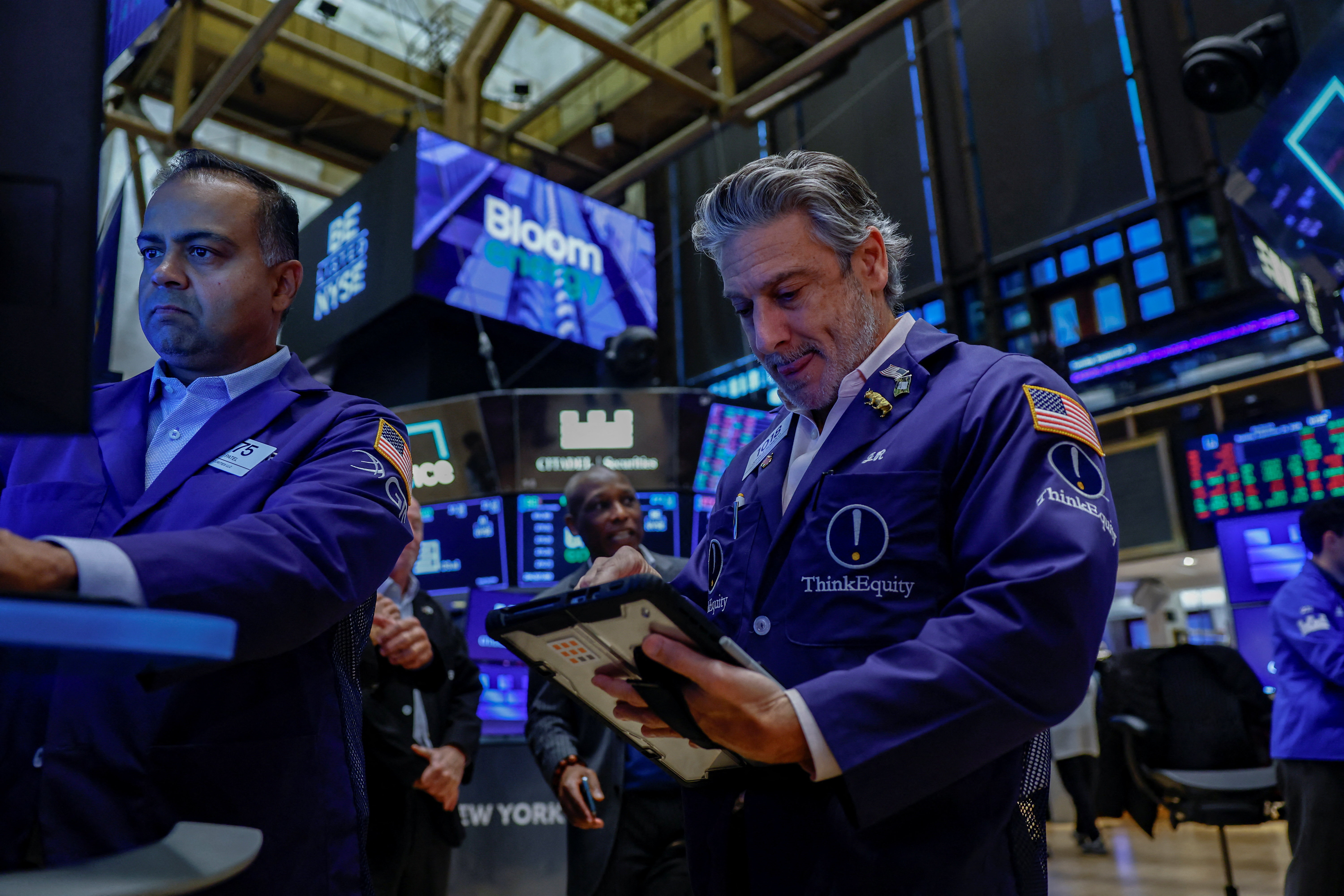 Traders work on the floor at the New York Stock Exchange