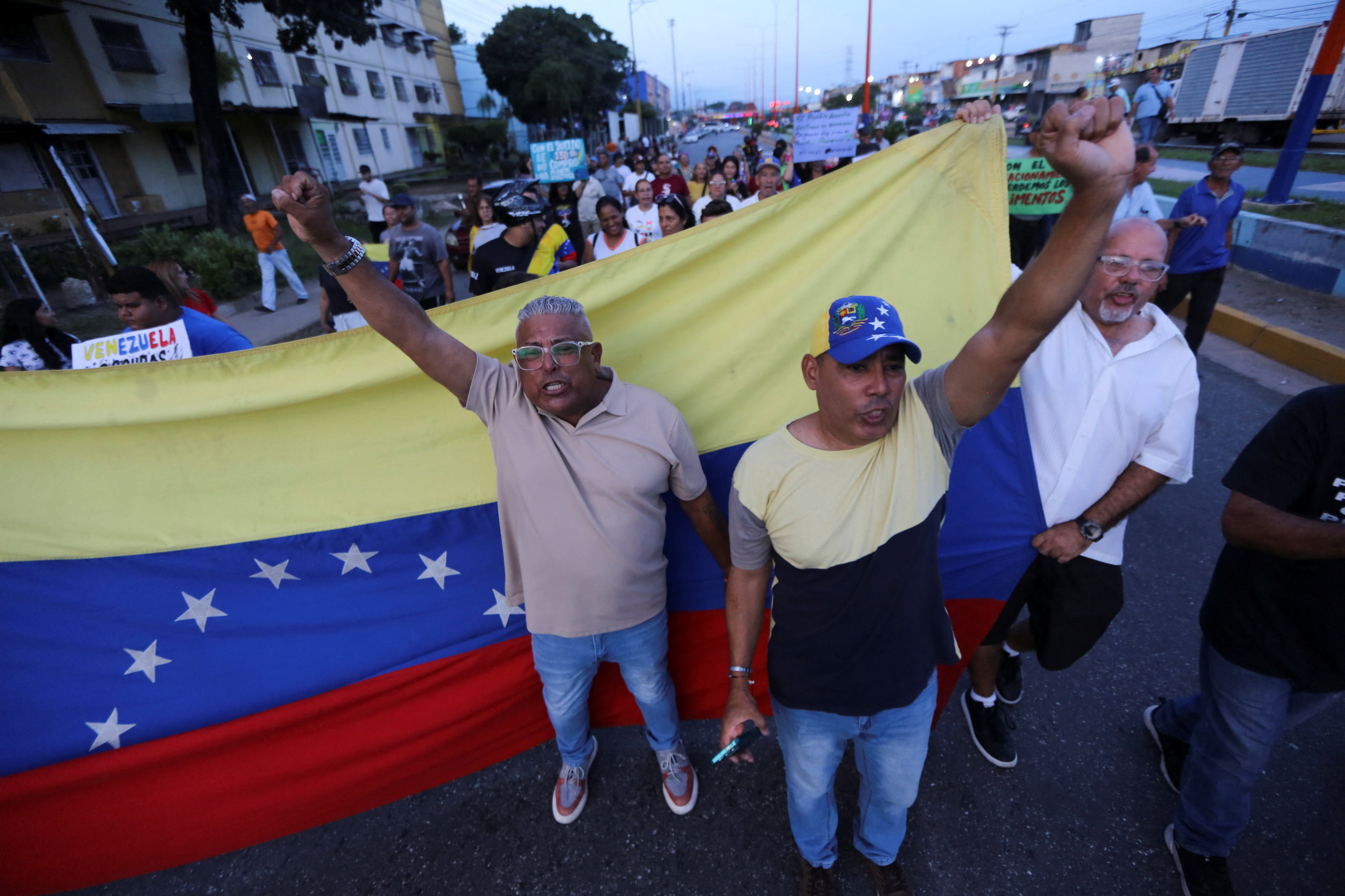 Demonstrators raise their fists as they take part in a protest against prolonged power outages in Valencia, Venezuela, October 2, 2026. REUTERS/Juan Carlos Hernandez