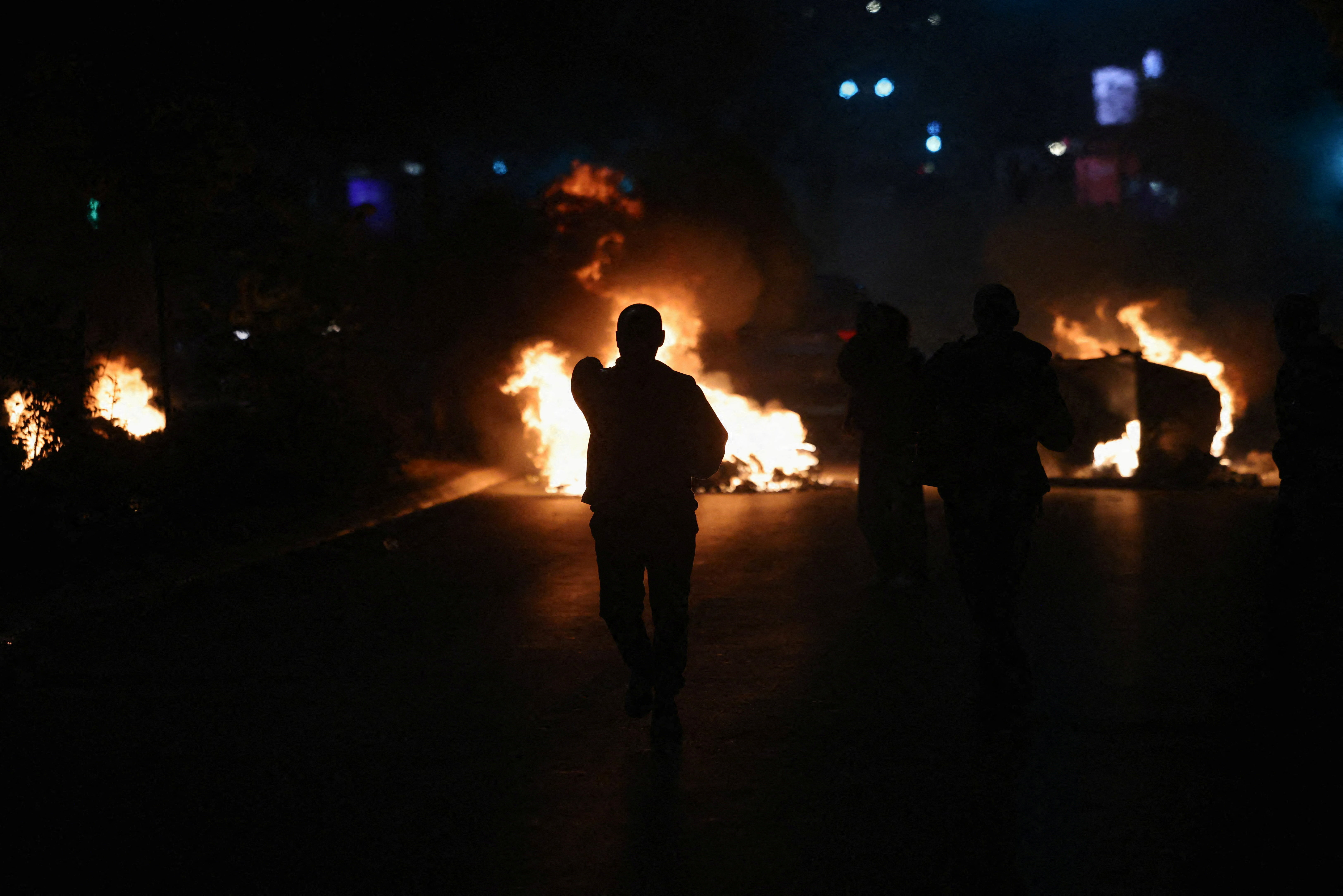 Flames rise during a protest against the war crimes convictions of former KLA leaders in Pristina, Kosovo, on October 5