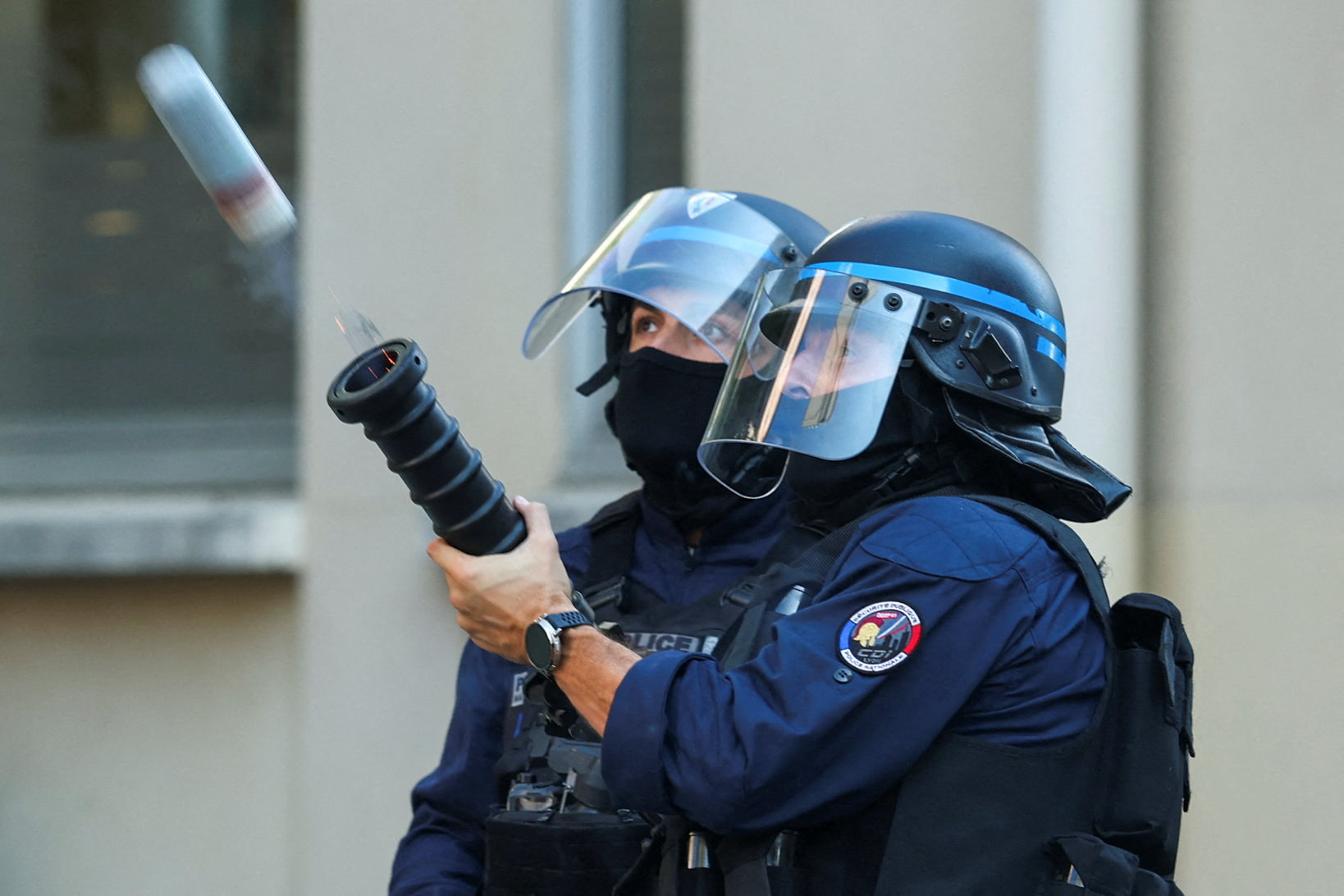 French riot police officer fires a crowd-control weapon during a demonstration by French high school and university students in Lyon as part of a nationwide day of protests and blockades, voicing anger over overcrowded classrooms, teacher shortages and dilapidated school buildings, which students blame on years of underinvestment, France, October 6, 2026. REUTERS/Denis Balibouse TPX IMAGES OF THE DAY