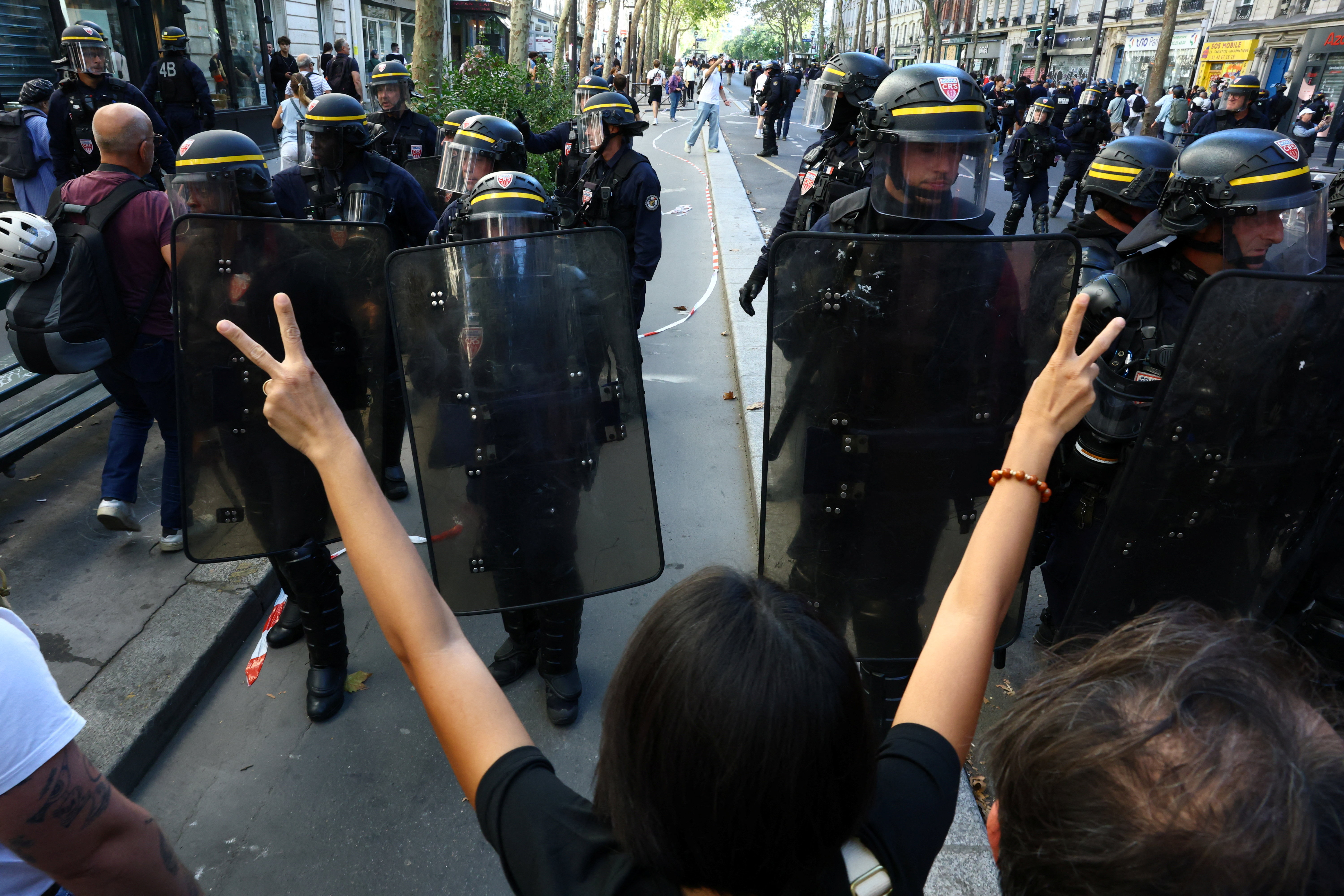 Riot police face high school students