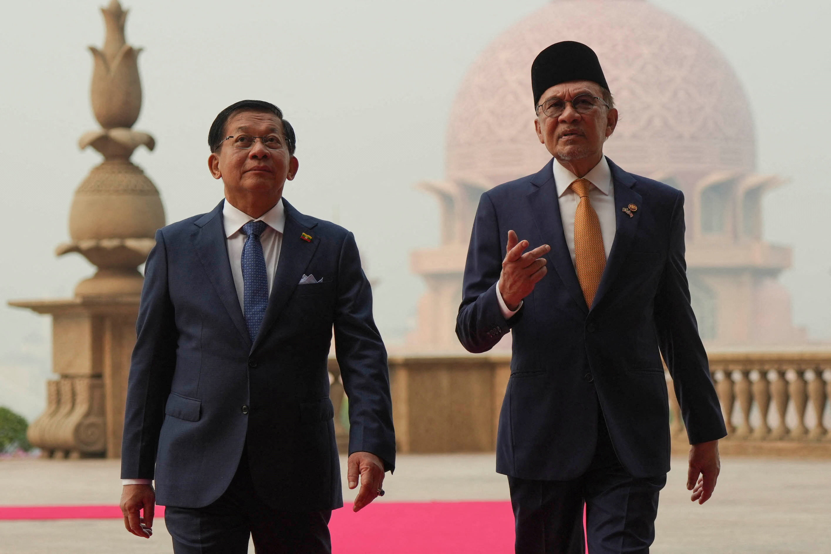 Myanmar’s President Min Aung Hlaing walks with Malaysia’s Prime Minister Anwar Ibrahim.