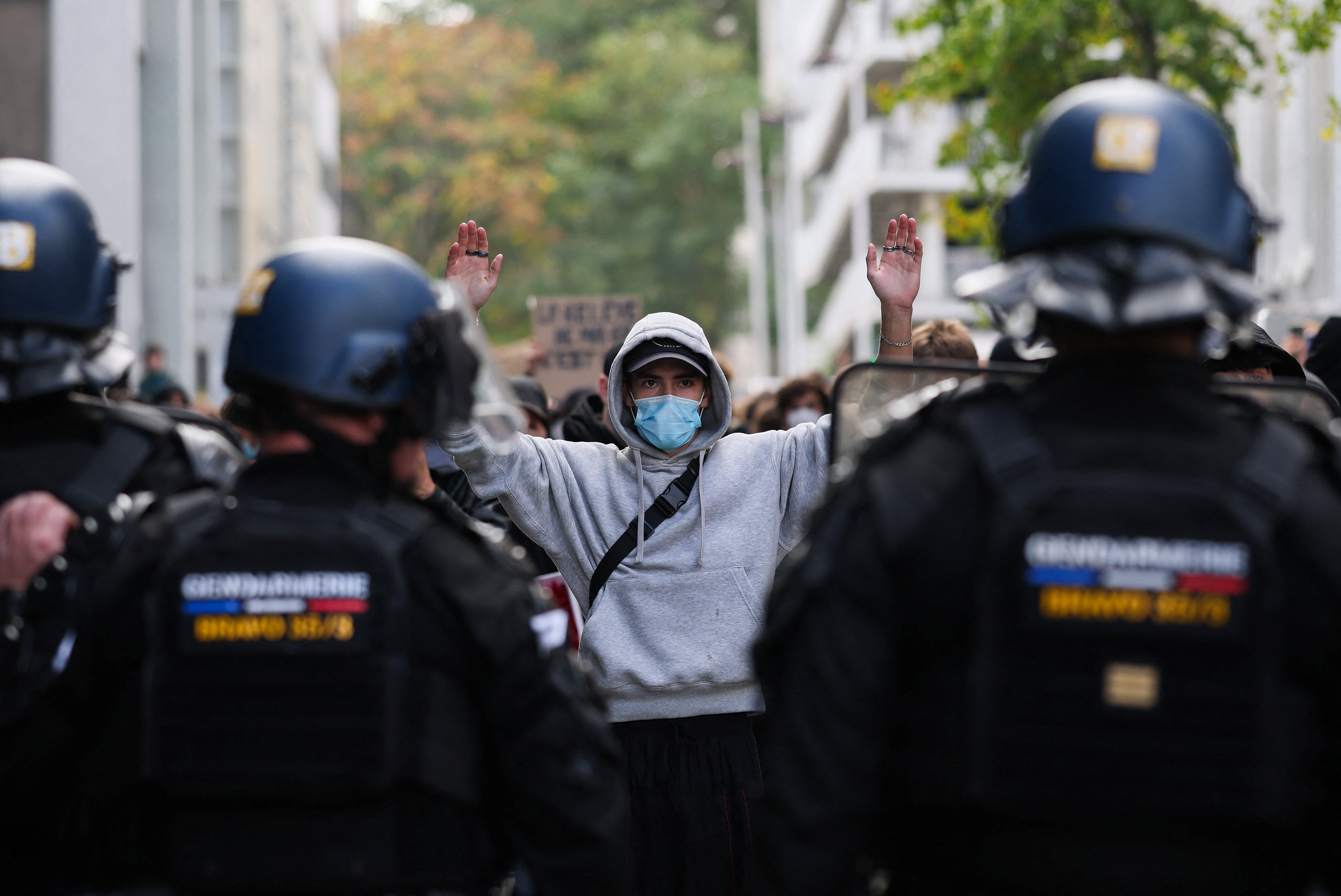 A protestor holds his hands up in front of riot police, as French high school and university students attend a demonstration in Nantes, part of a nationwide day of protests and blockades to demand better school conditions in France, October 8, 2026. REUTERS/Stephane Mahe