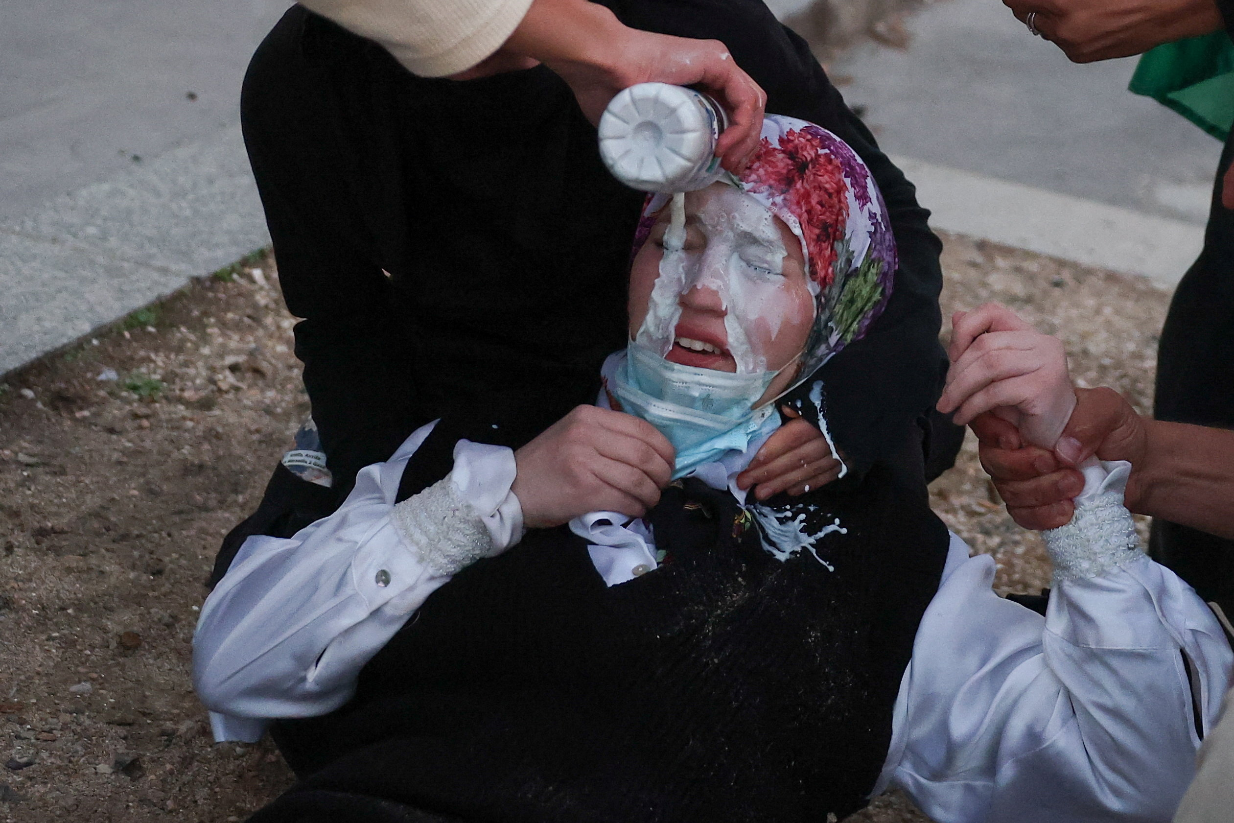 A demonstrator is treated with milk after exposure to tear gas during nationwide protests in Paris, France, October 8, 2026, to demand better school conditions. REUTERS/Pedro Nunes