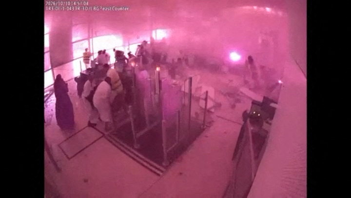 Surveillance footage shows smoke and fire as people react at the moment of an attack at King Khalid International Airport in Riyadh, Saudi Arabia, October 10, 2026, in this frame from a handout video. Saudi Ministry of Media/