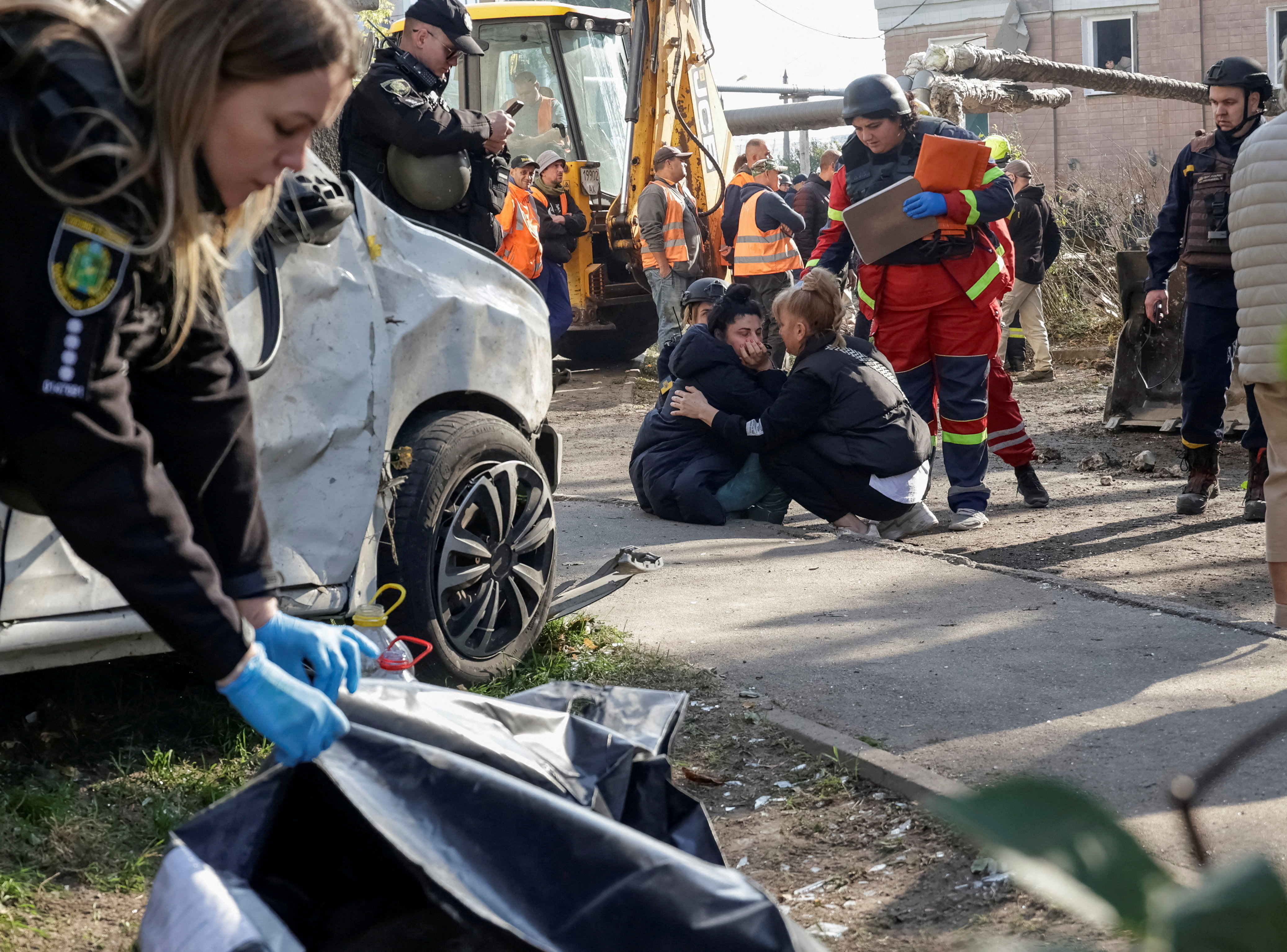 A daughter of a killed woman, found under debris, reacts at a site of an apartment building damaged during a Russian jet drone strike, amid Russia's attack on Ukraine, in Kharkiv, Ukraine October 13, 2026. REUTERS/Sofiia Gatilova TPX IMAGES OF THE DAY