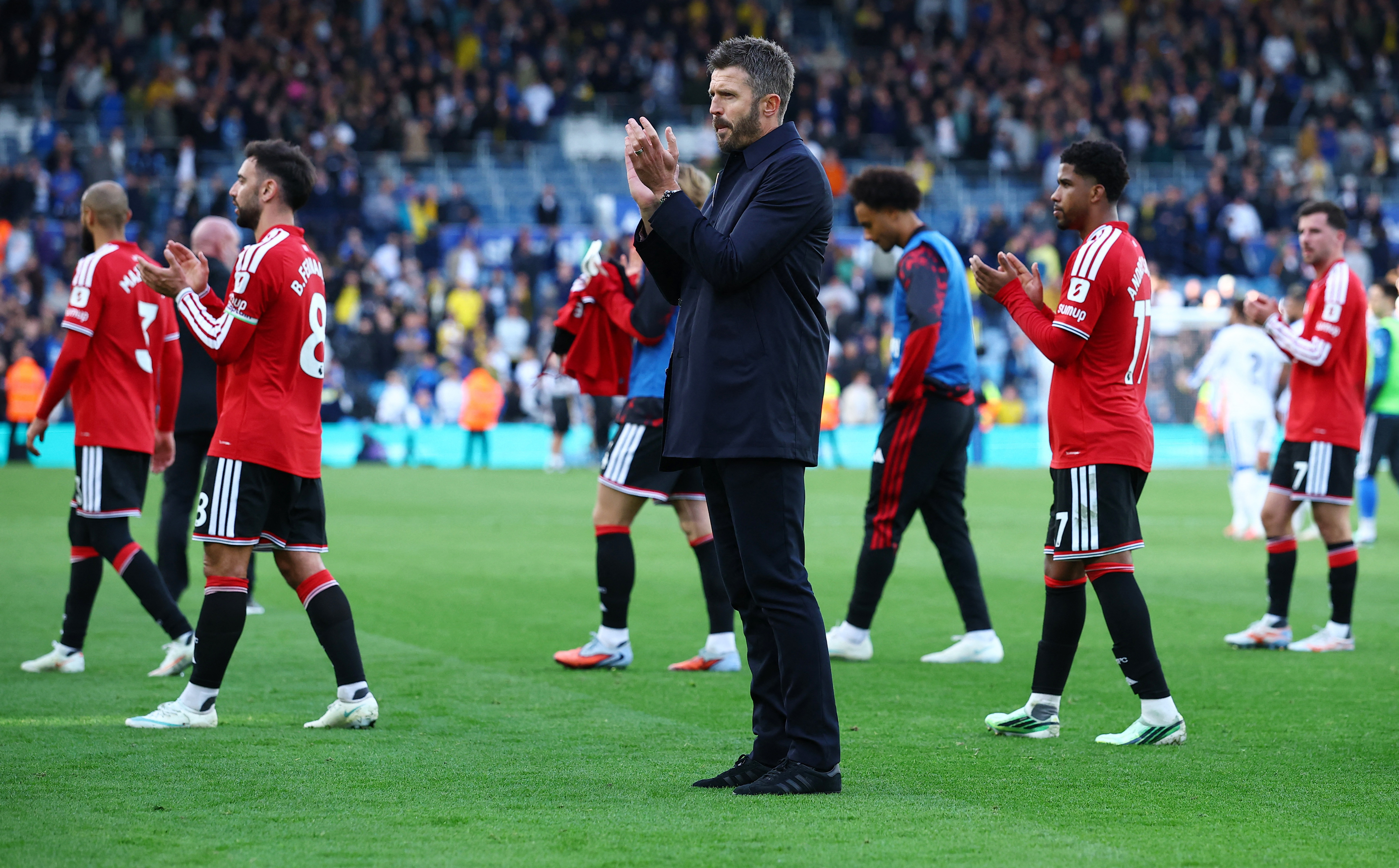 Manchester United manager Michael Carrick applauds fans after the match