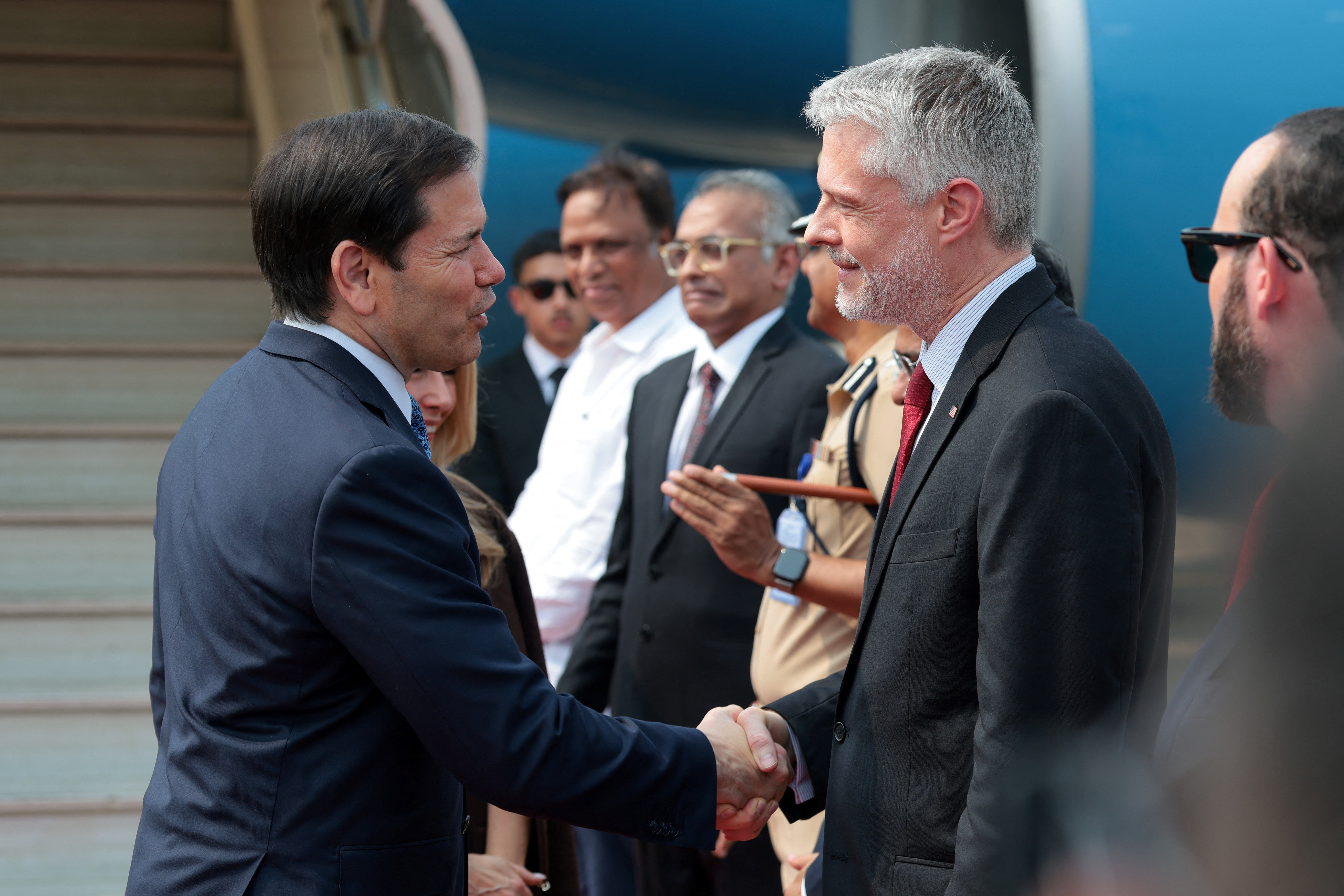 Secretary of State Marco Rubio shakes hands with US Consul-General in Mumbai Yuriy Fedkiw as he disembarks from a plane after arriving at Mumbai airport in India, October 20, 2026