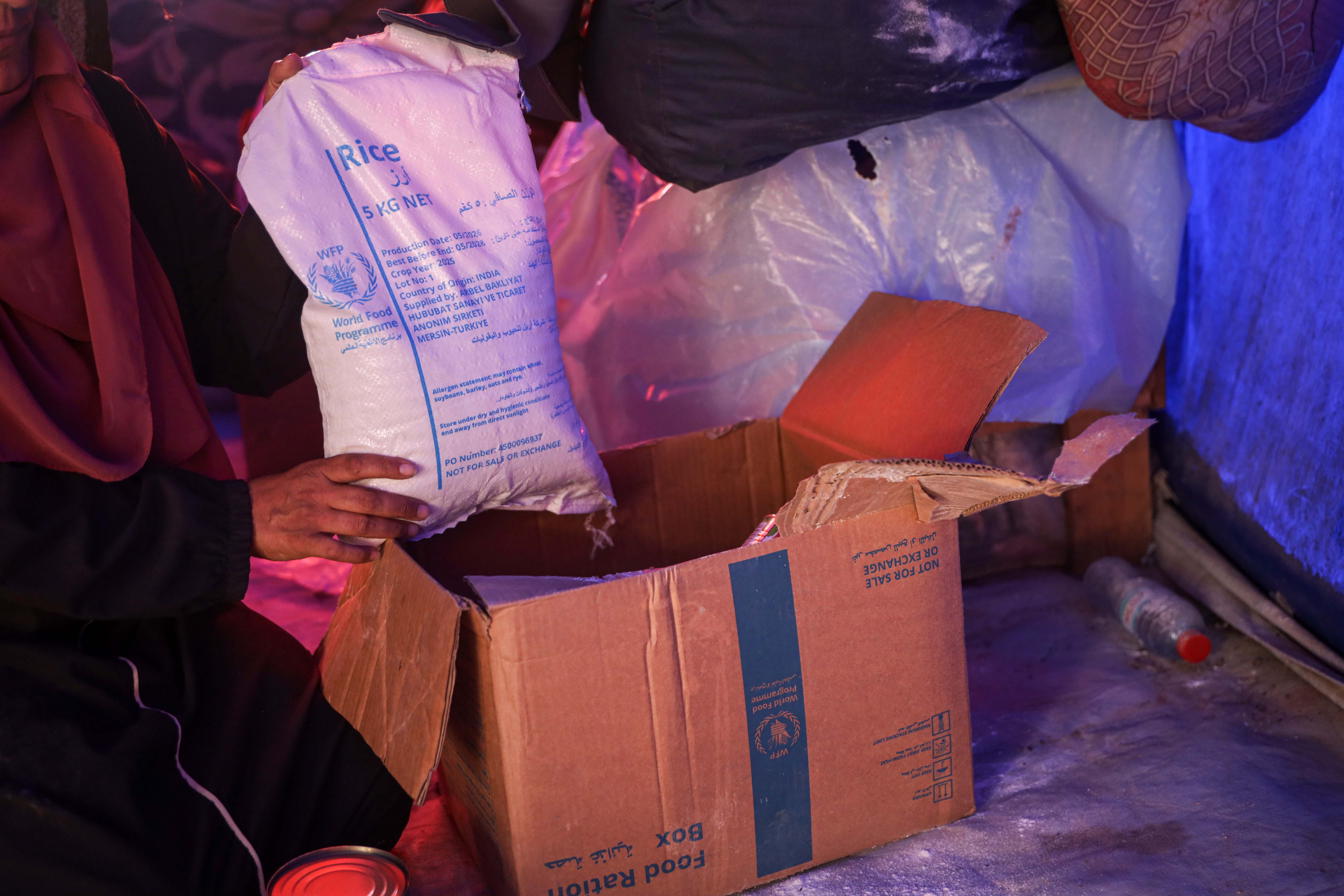 The World Food Programme’s most recognisable food parcel in Gaza contains flour, rice, cooking oil and other essential food items. [Abdelhakim Abu Riash/Al Jazeera]