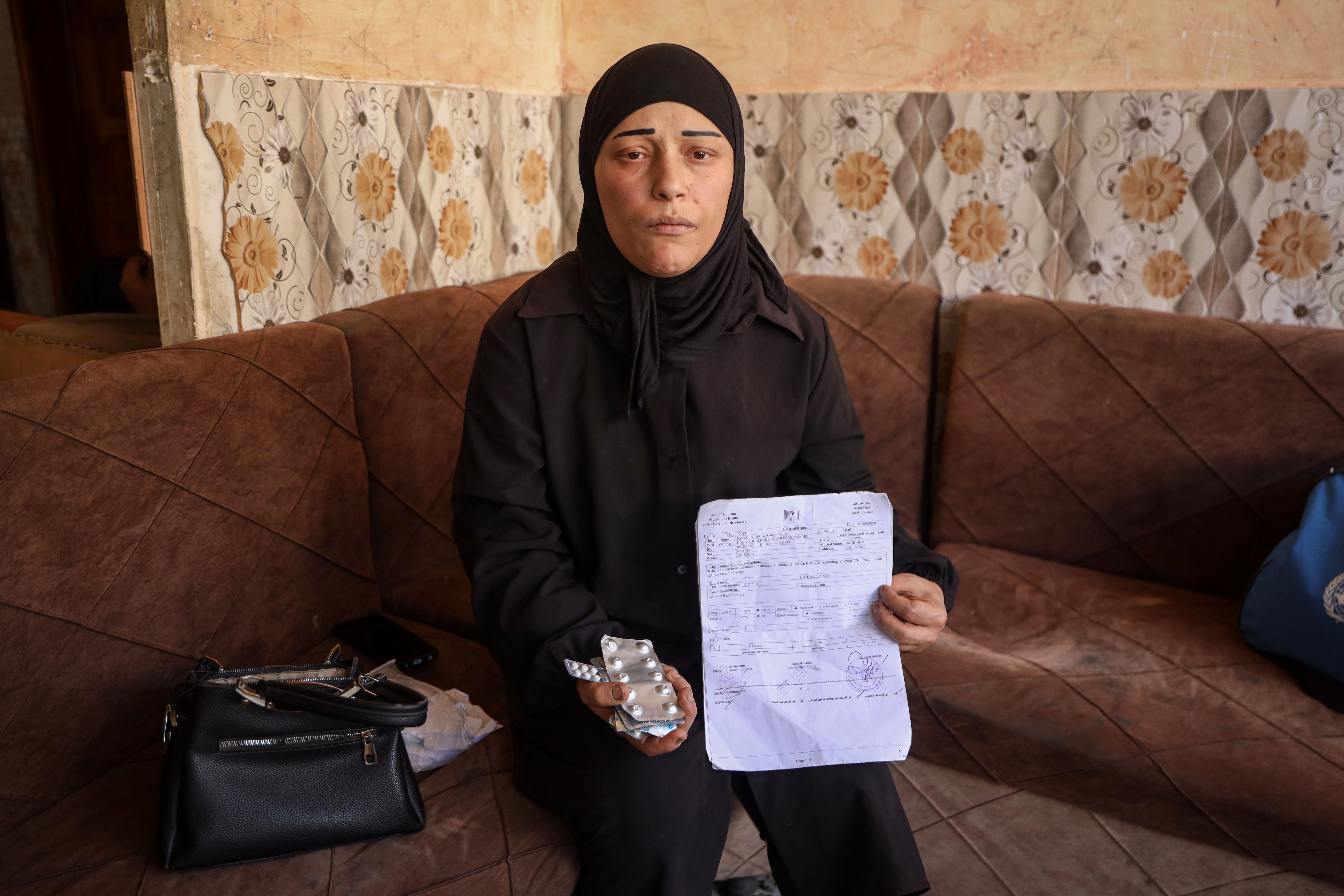 Hiba Musbah, 36, has been battling breast cancer in Gaza since 2024, facing delays in treatment and shortages of medicine. [Abdelhakim Abu Riash/ Al Jazeera]