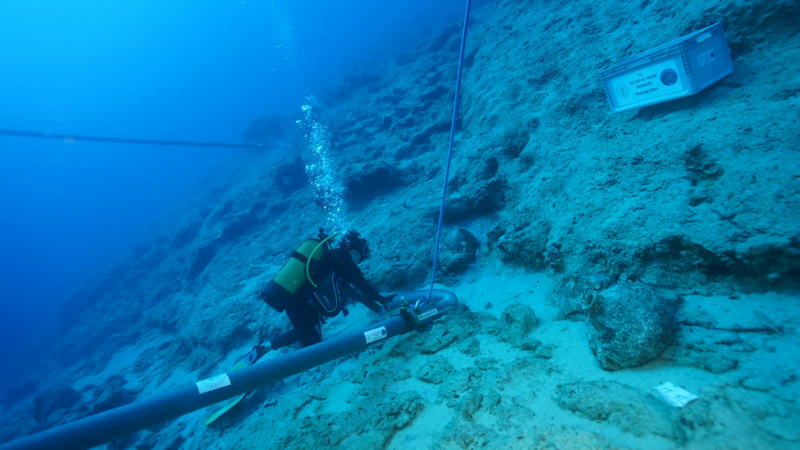 ANTALYA, TURKIYE - OCTOBER 13: (----EDITORIAL USE ONLY MANDATORY CREDIT - 'TURKISH CULTURE AND TOURISM MINISTRY / HANDOUT' - NO MARKETING NO ADVERTISING CAMPAIGNS - DISTRIBUTED AS A SERVICE TO CLIENTS----) A diver handles a container during underwater archaeological excavations near Kekova Island in Antalya, Turkiye, on October 14, 2026. The excavations have uncovered approximately 4,700-year-old amphorae believed to belong to what is described as the world's oldest known shipwreck. Turkish Minister of Culture and Tourism Mehmet Nuri Ersoy announced that the vessels, thought to have been used to transport olive oil or wine, provide insights into ancient maritime trade networks across the Eastern Mediterranean. ( TUR Ministry of Culture and Tourism - Anadolu Agency )