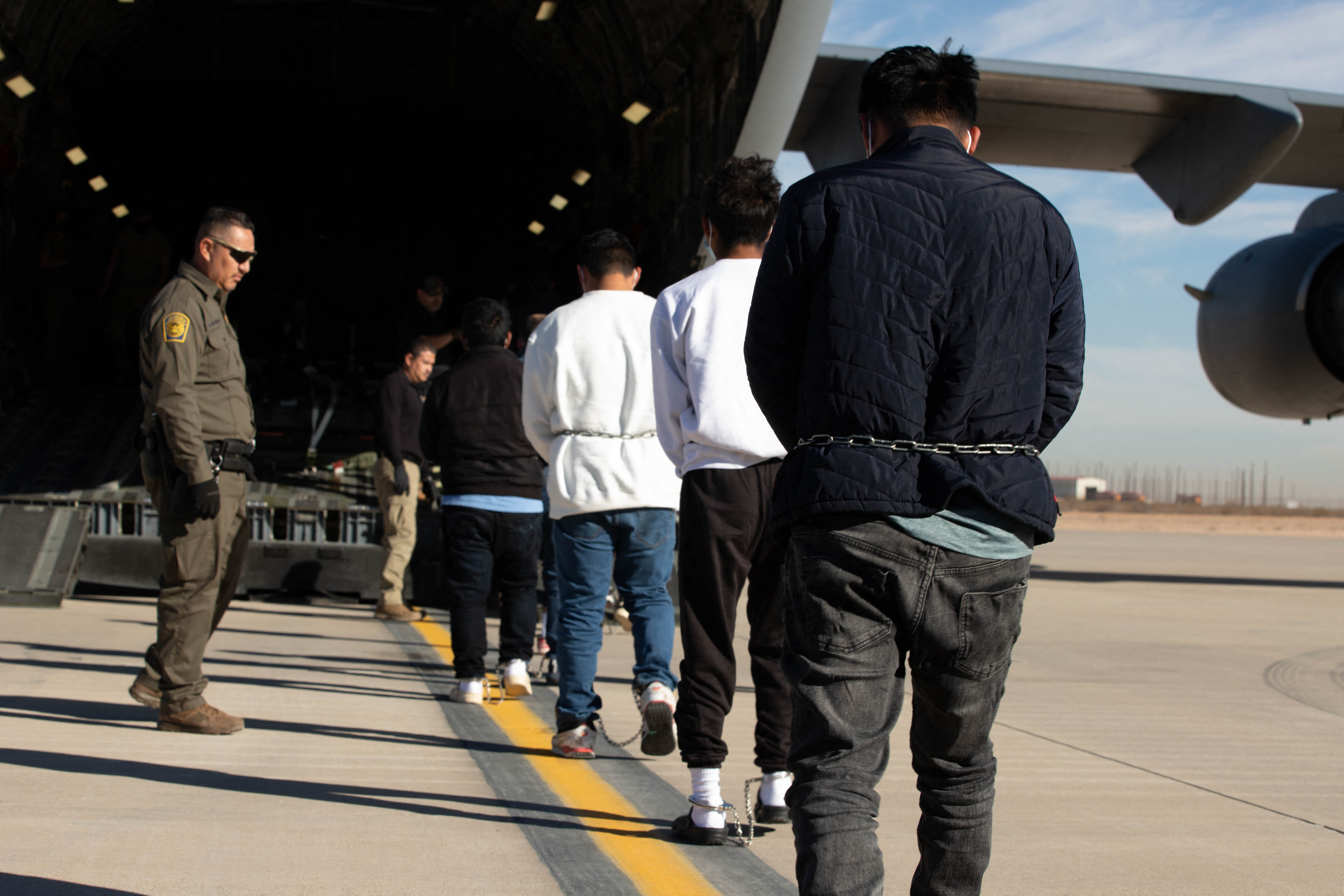 Line of deportees heading into a plane