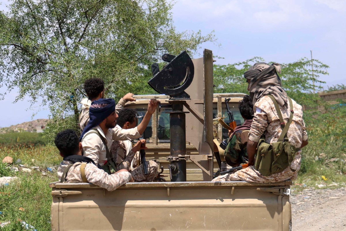 Saudi-backed Yemeni government forces ride in the back of a military truck at the Jabal Han front west of the city of Taiz