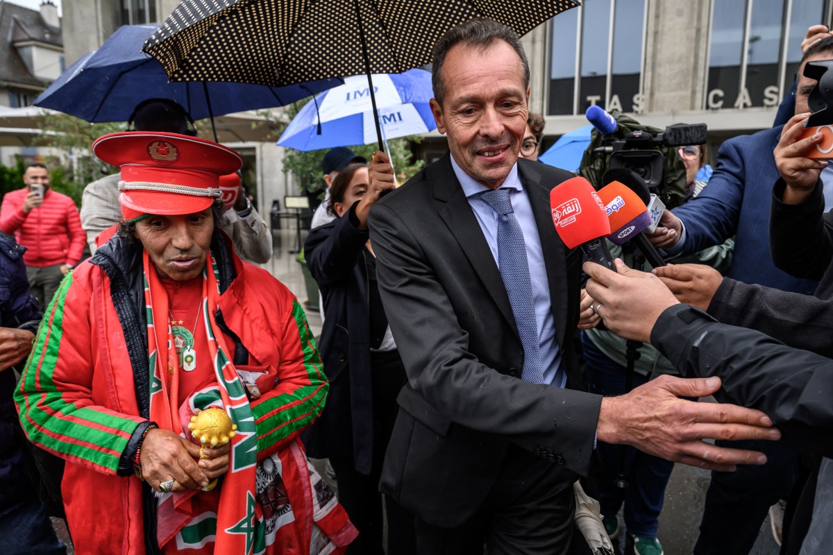 Secretary General of the Royal Moroccan Football Federation Tarik Najem (R) gestures next to Moroccan supporter Noureddine Falah, aka Dolmy (L) at the end of a hearing at the Court of Arbitration for Sport (CAS) on Senegals appeal against Morocco after a chaotic Africa Cup of Nations football final