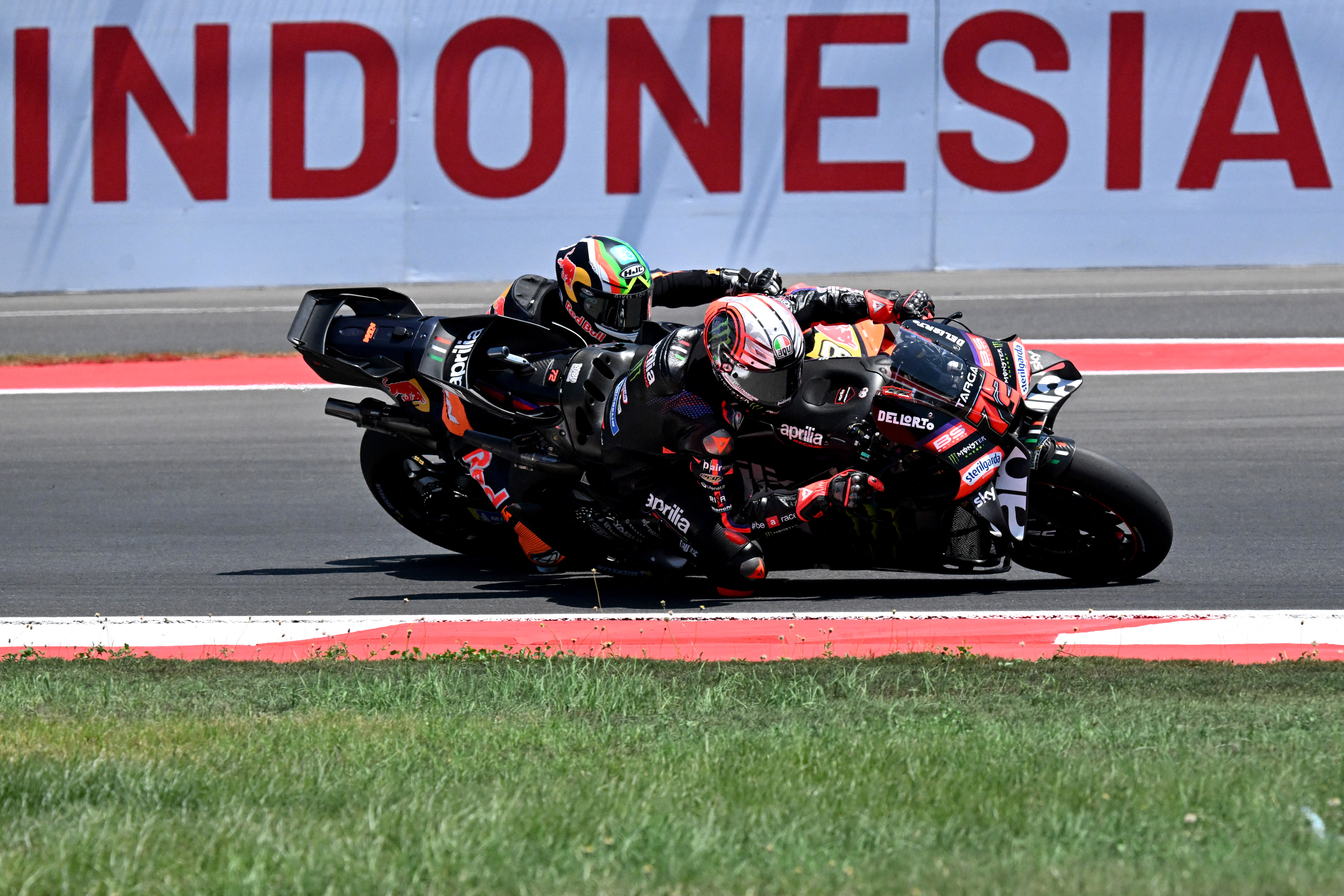 Aprilia Racing rider Marco Bezzecchi of Italy (front) takes part in a free practice ahead of the MotoGP Indonesian Grand Prix at the Mandalika International Circuit in Mandalika on October 9, 2026. (Photo by SONNY TUMBELAKA / AFP)