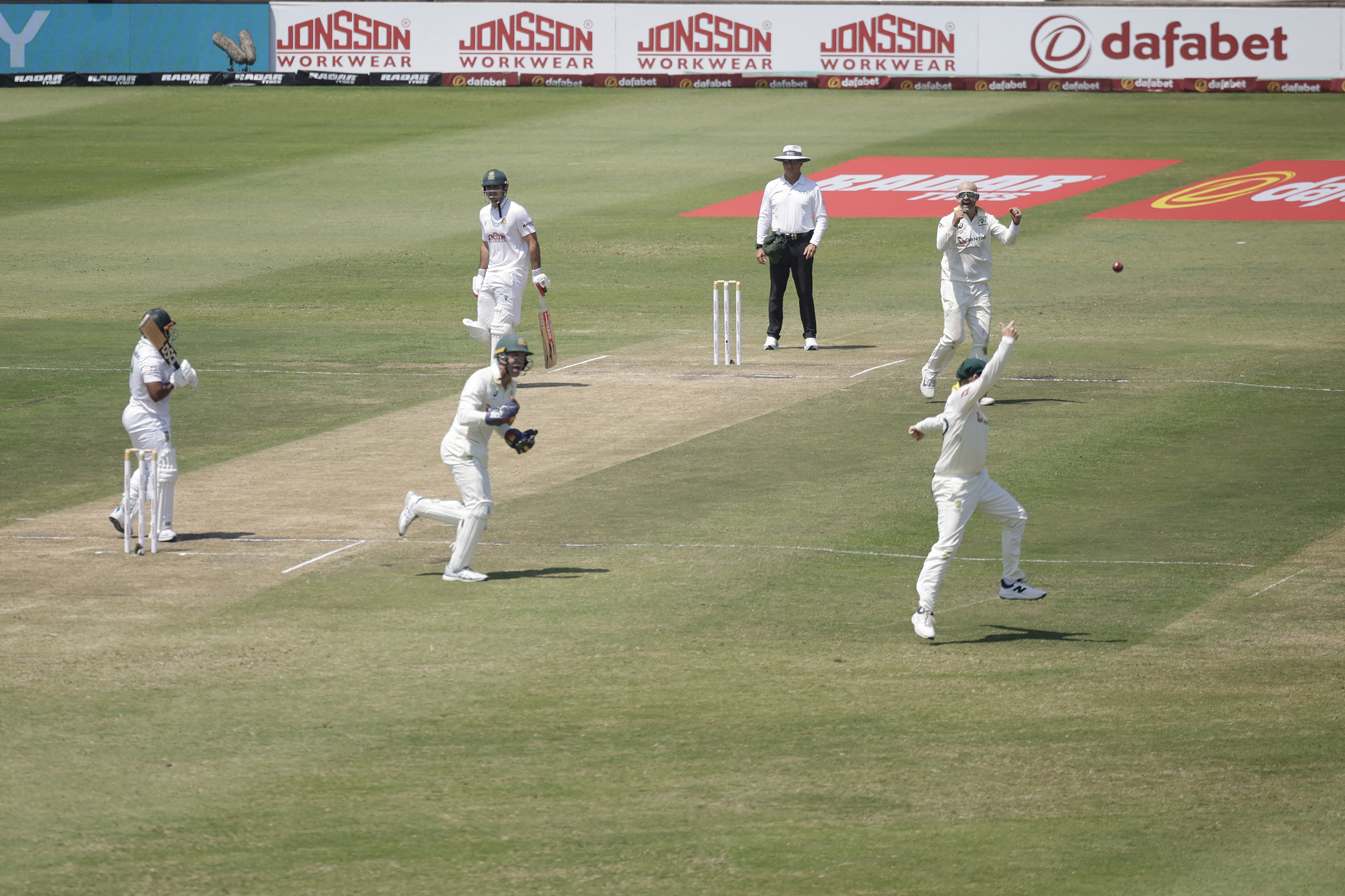 Australia's Steve Smith tosses the ball after dismissing South Africa's Temba Bavuma on day three of the first Test match between South Africa and Australia at the Kingsmead stadium in Durban on October 11, 2026. (Photo by Marco Longari / AFP)