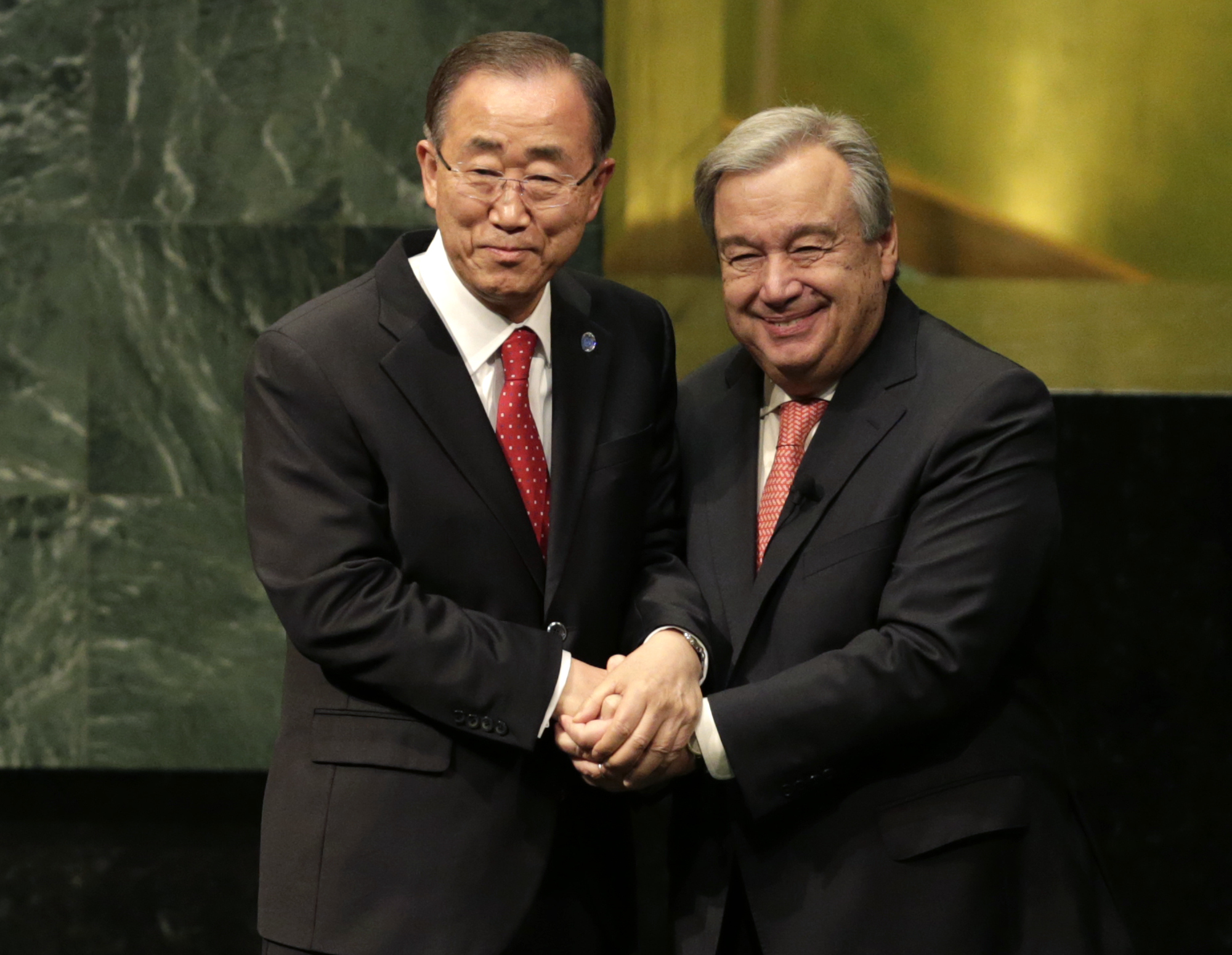 Then-Secretary-General Ban Ki-moon, left, clasps hands with U.N. Secretary-General designate Antonio Guterres after Guterres was sworn in at U.N. headquarters, on Monday, Dec. 12, 2016 [Seth Wenig/AP]