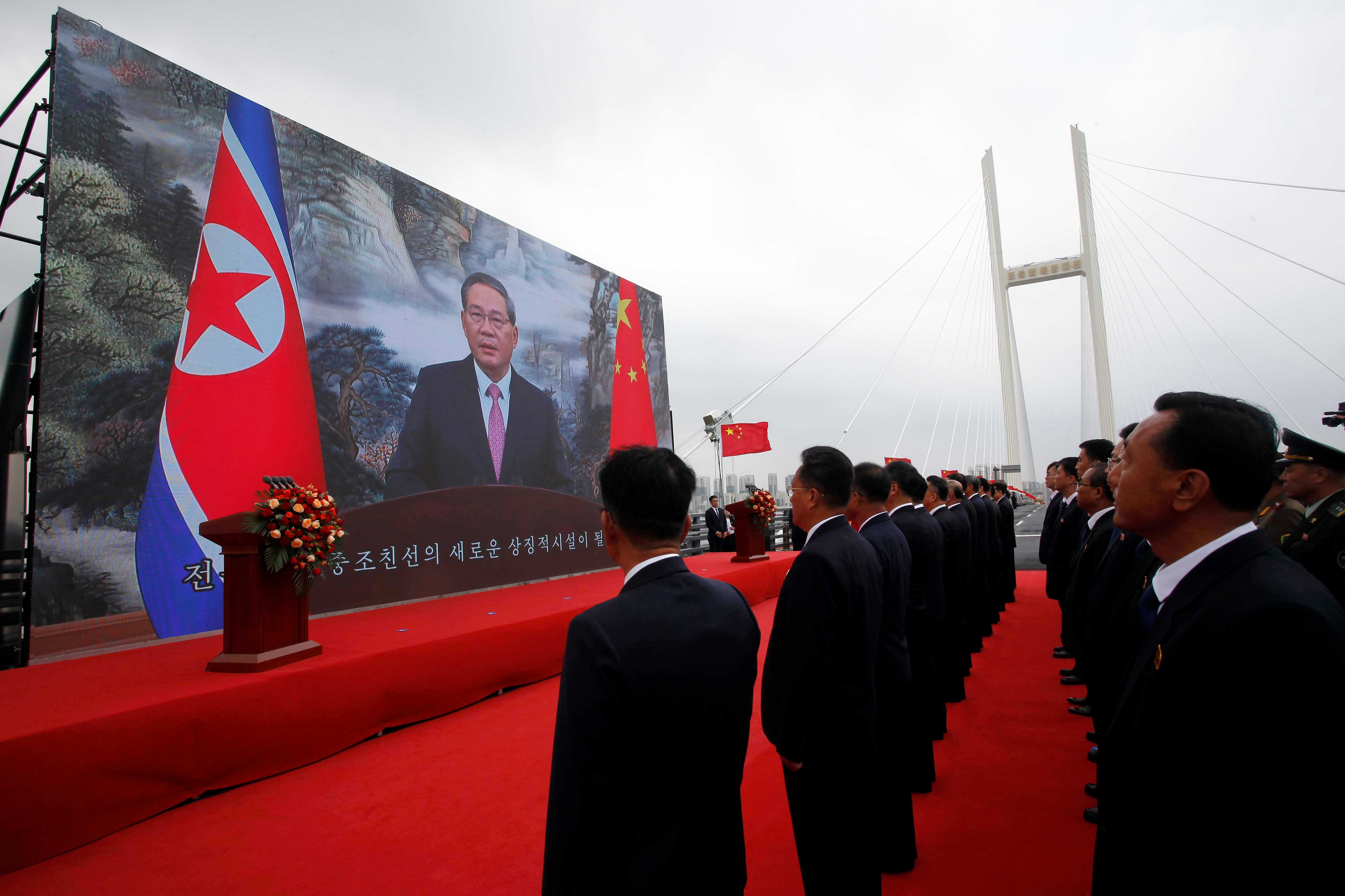 Chinese Premier Li Qiang, on screen, makes a speech through video conference as a new bridge linking China and North Korea opens in North Phyongan province, North Korea, Thursday, October 15, 2026