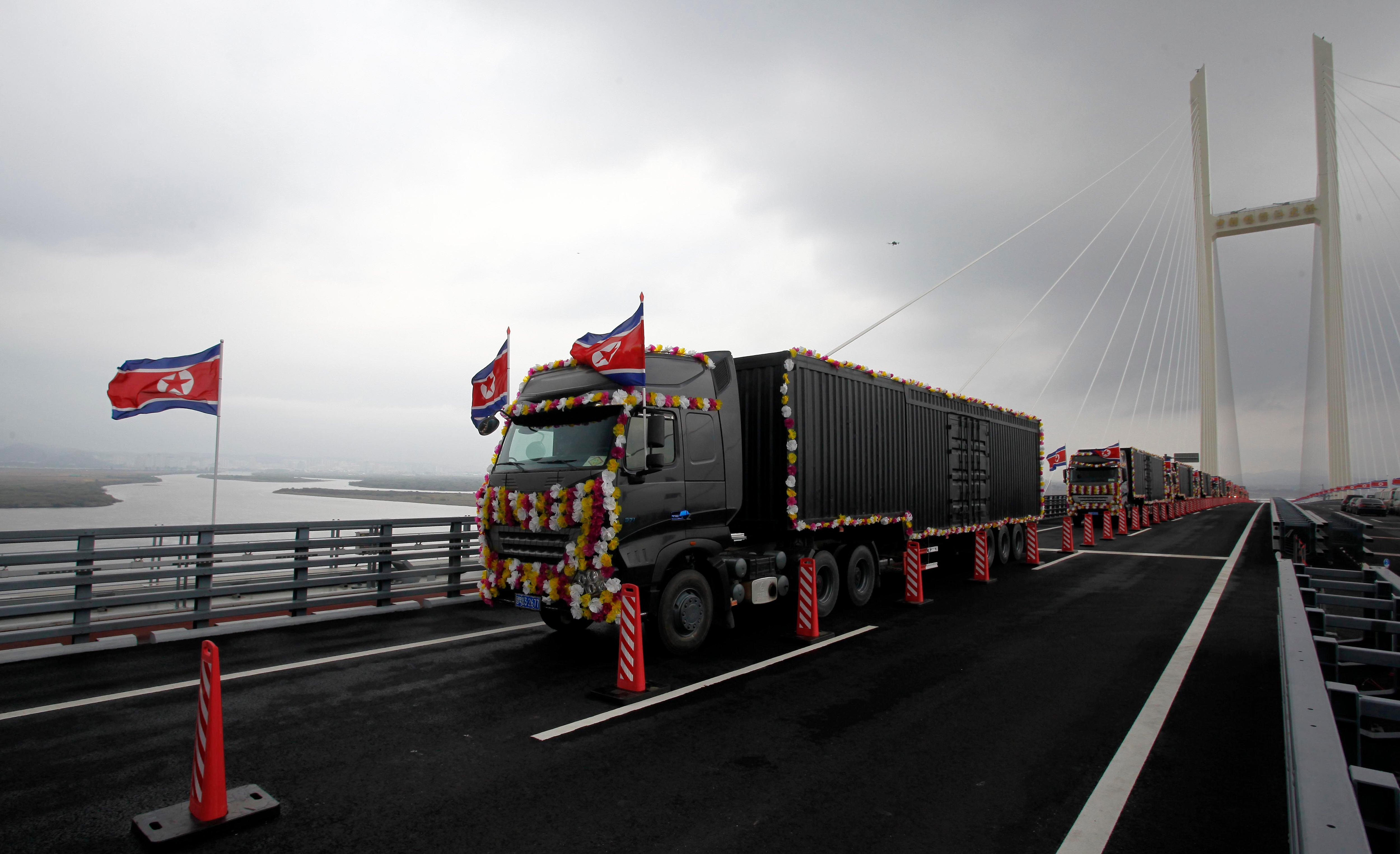 Vehicles drive through a new bridge linking China and North Korea as it opened in North Phyongan province, North Korea, on October 15, 2026