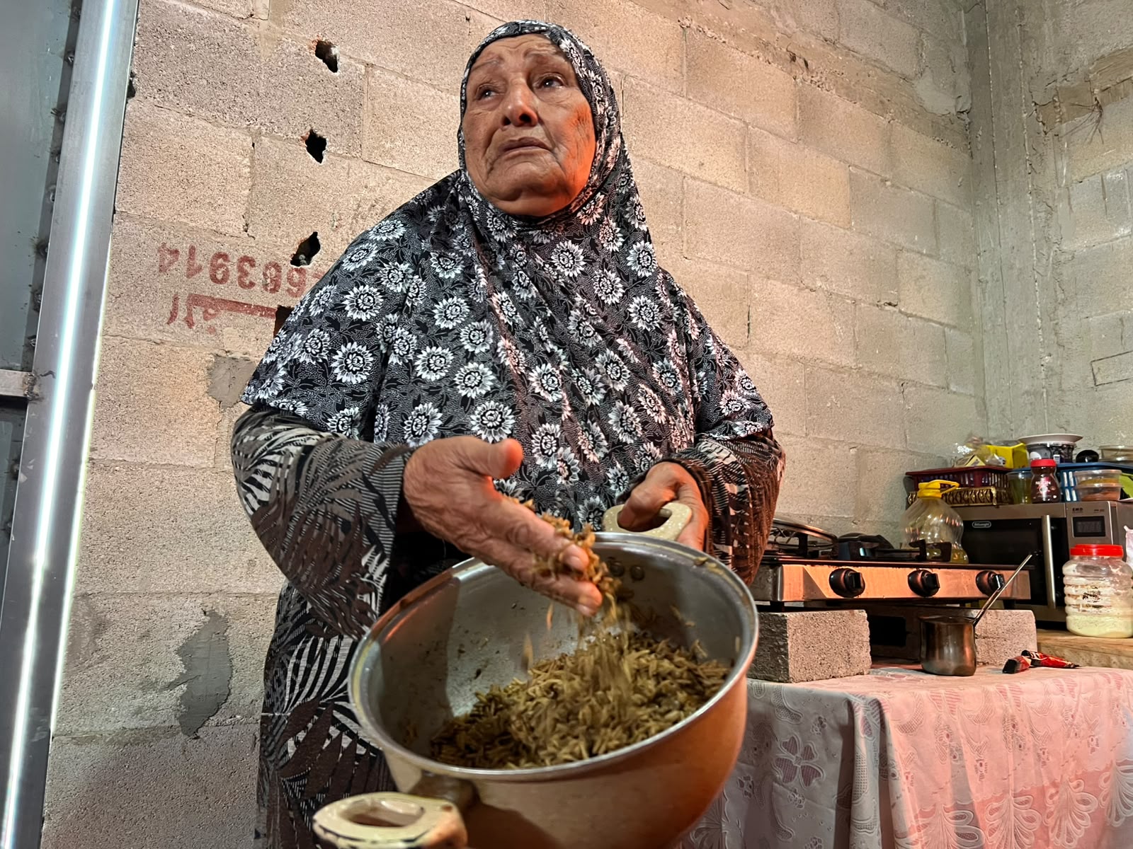 Elderly woman holds an empty pot