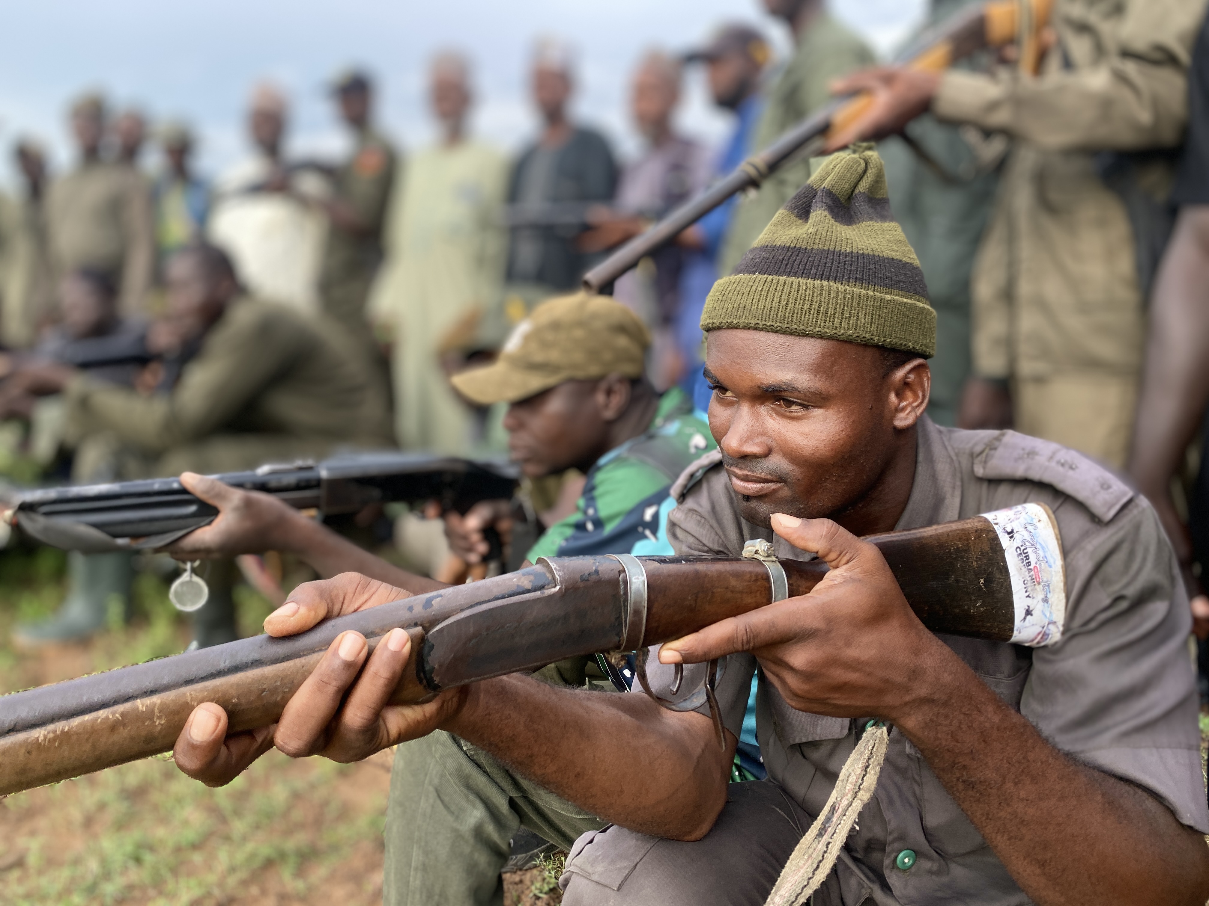 Armed men point their guns.