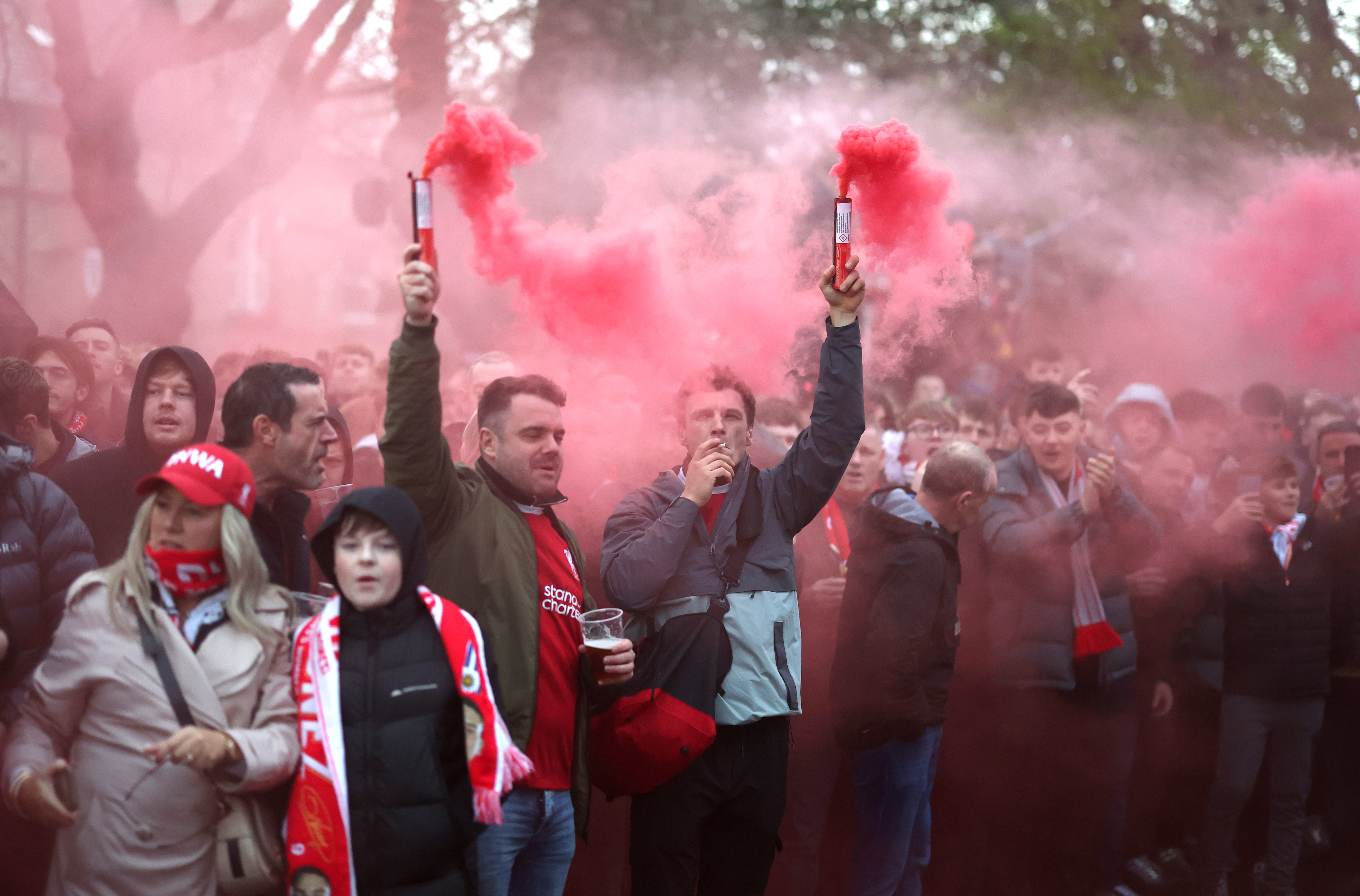 LIVERPOOL, ENGLAND - DECEMBER 01: Fans of Liverpool set off flares as they prepare to meet the team coach outside the stadium prior to the Premier League match between Liverpool FC and Manchester City FC at Anfield on December 01, 2024 in Liverpool, England. (Photo by Carl Recine/Getty Images)