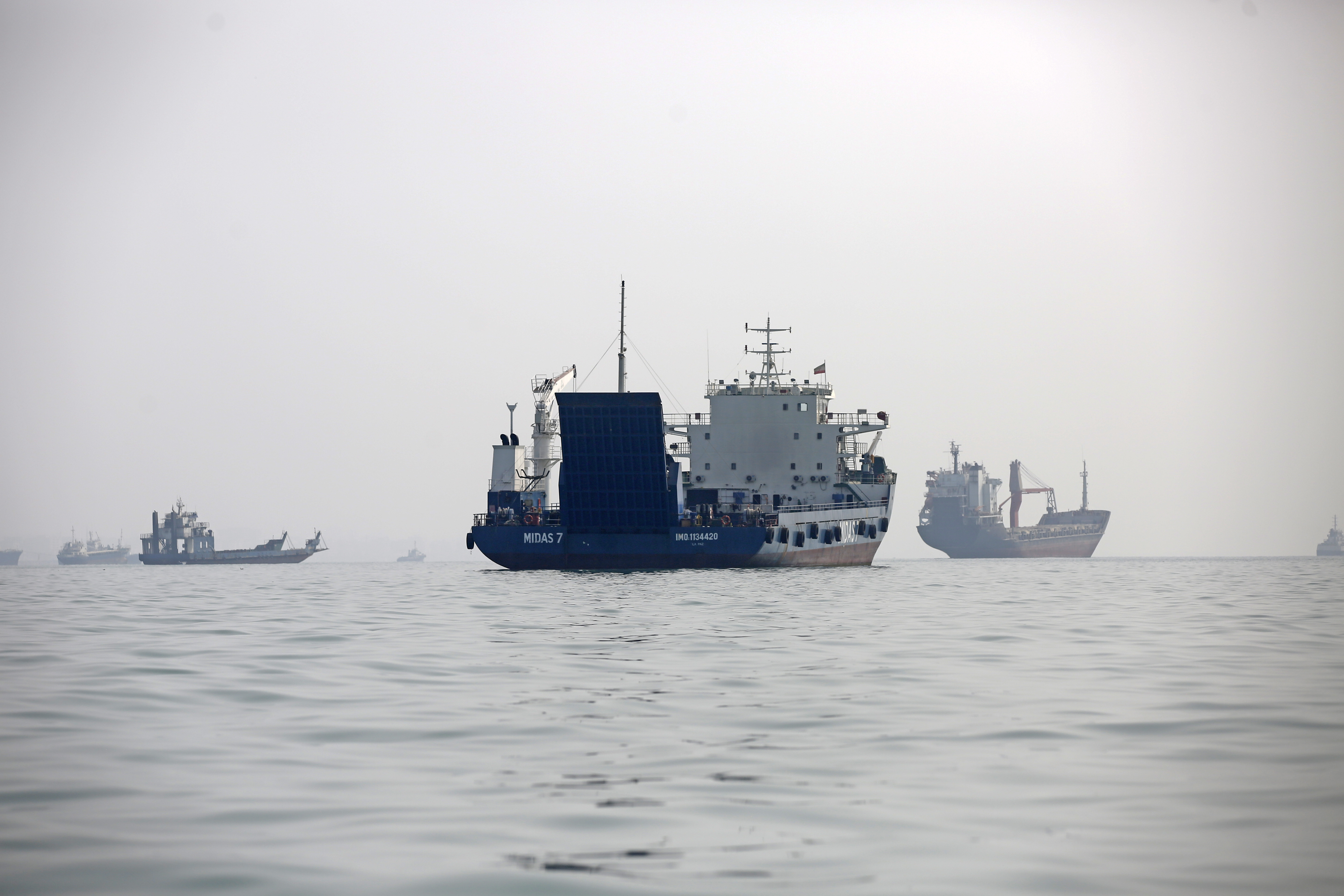 Commercial vessels and oil tankers sit anchored in the waters off Bandar Abbas in southern Iran's Hormozgan Province
