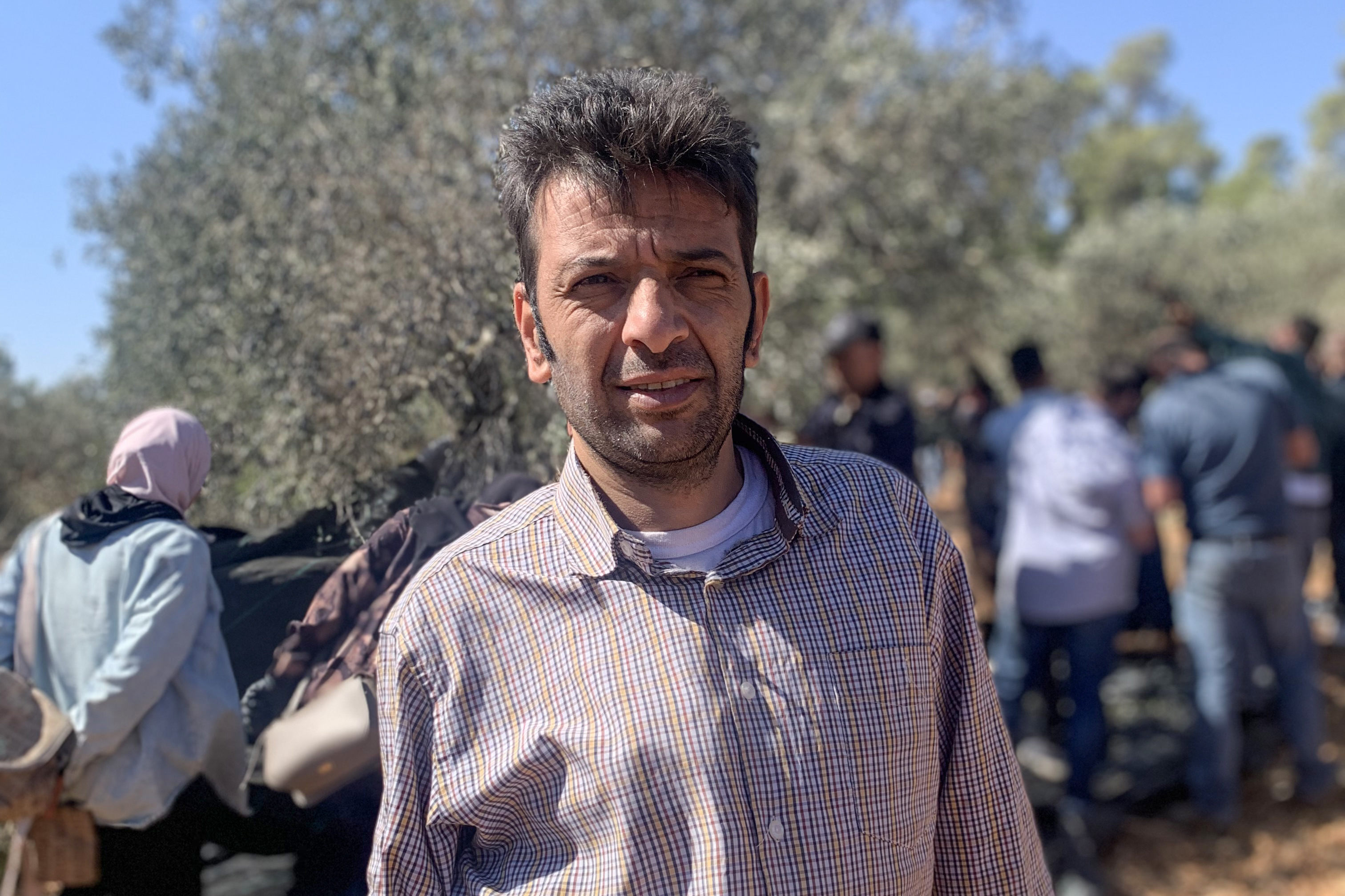 Marwan Sabah, mayor of Umm Safavillage, at a previous olive harvest [Al Jazeera]