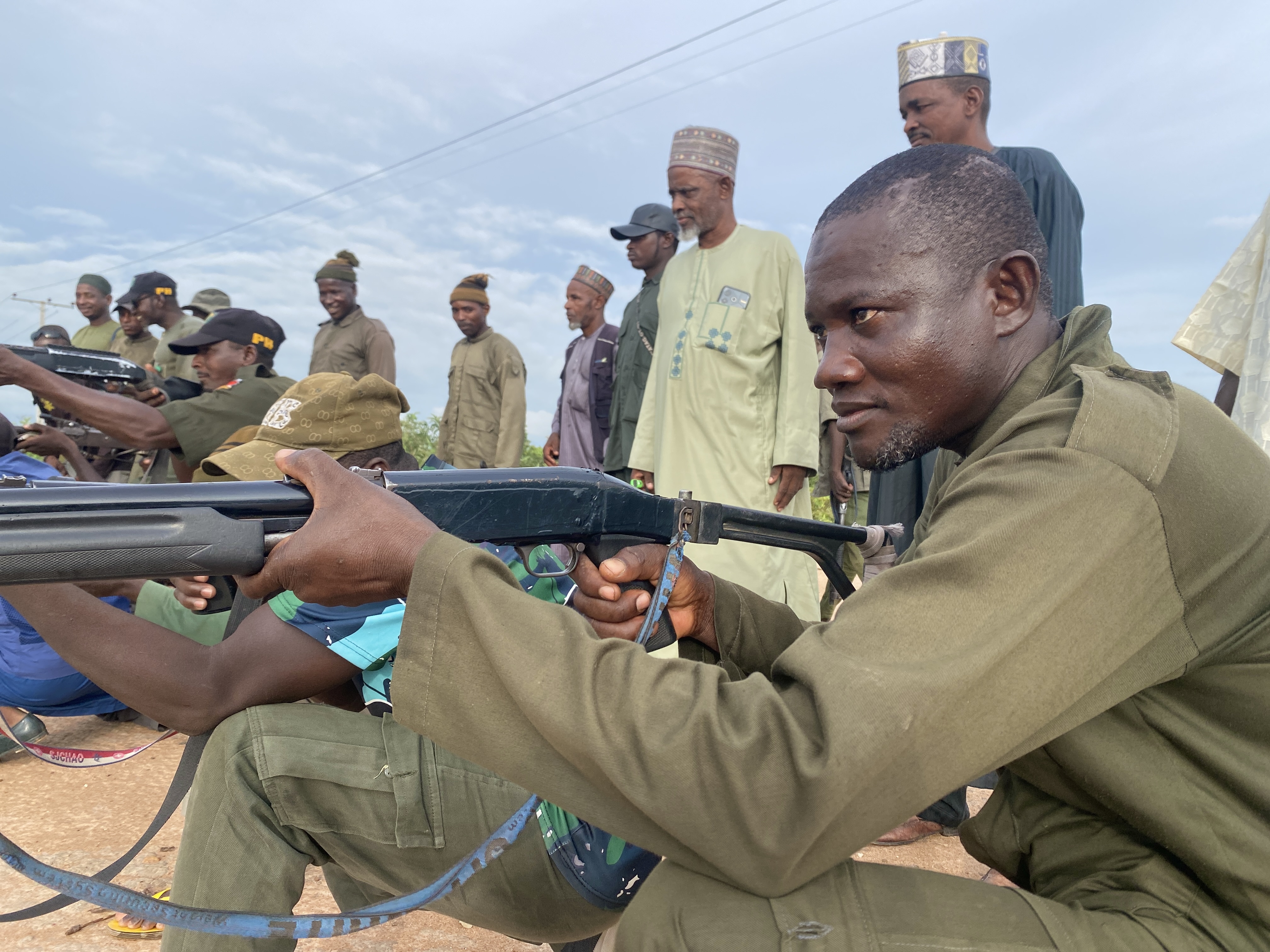Pulaku commander Musa Usman Malkohi stands behind members of the vigilante group during a training drill in Adamawa State, Nigeria