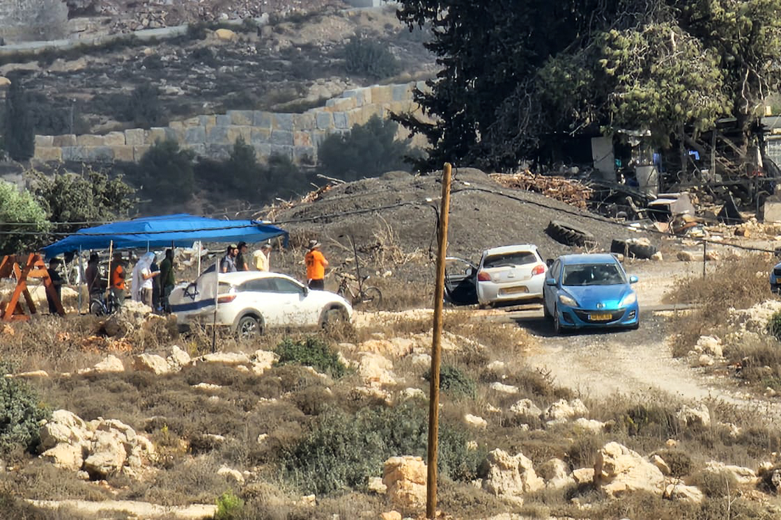 Photo of settlers posted outside Abayat home Umm Safa