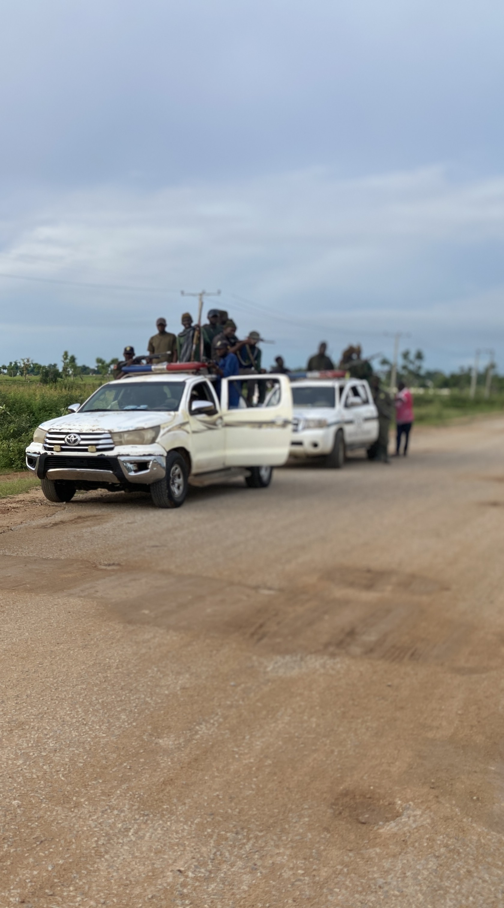 A convoy of Pulaku vigilantes travels through the savanna outside Yola, northeastern Nigeria, on its way to a training exercise