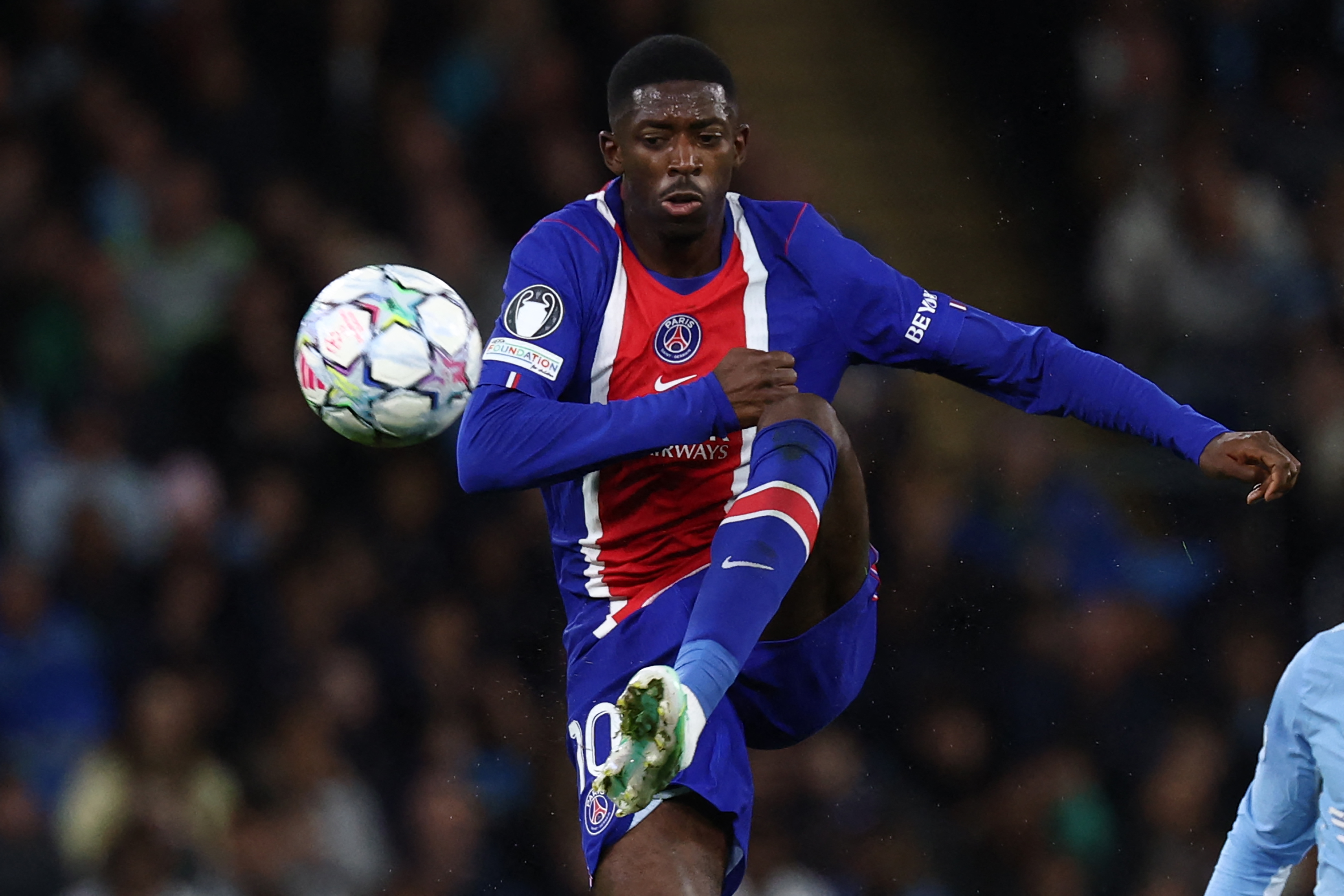 Paris Saint-Germain's French striker #10 Ousmane Dembele controls the ball during a game.