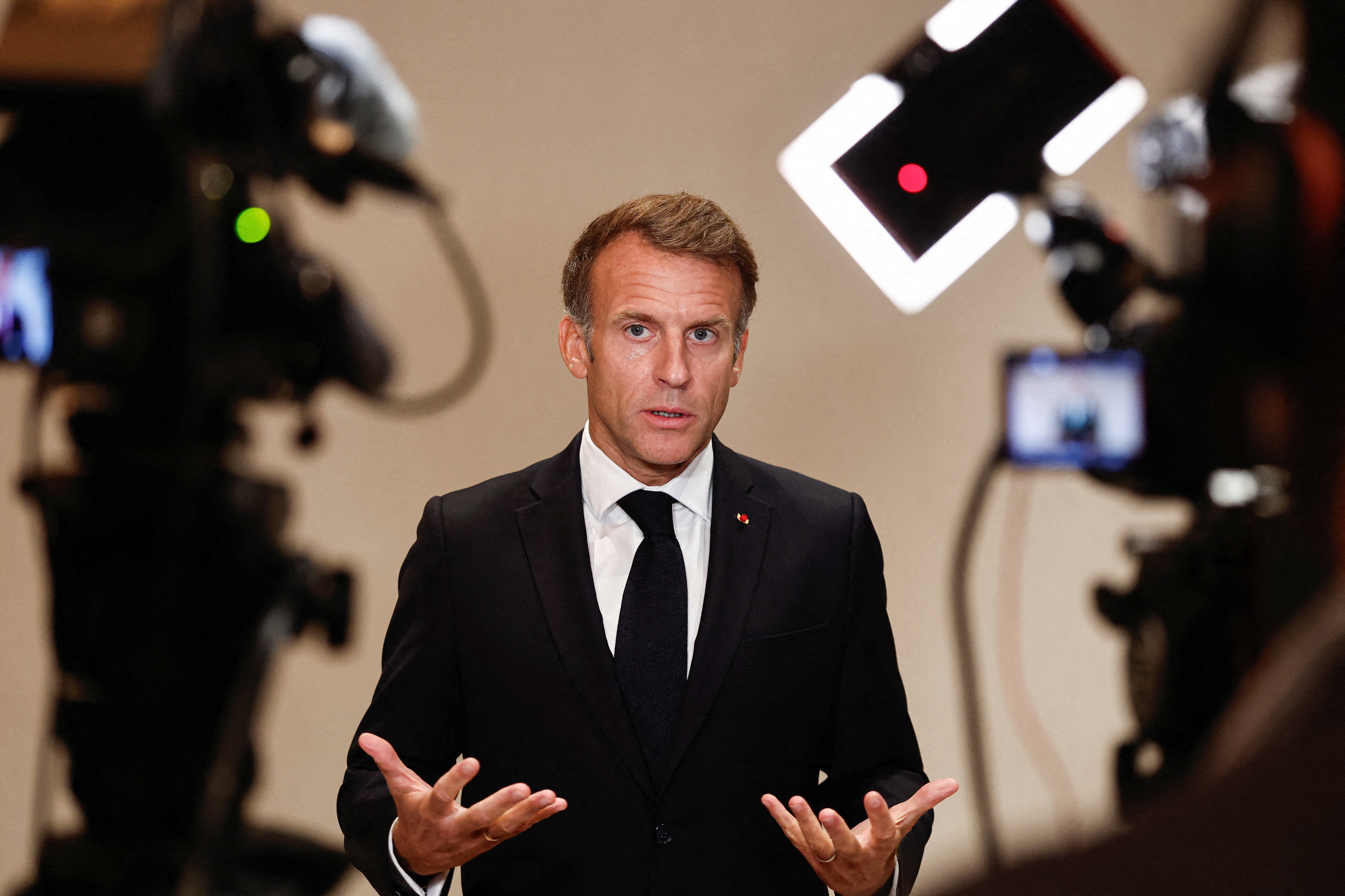 France's President Emmanuel Macron speaks to members of the media on the day of the 9th Annual One Planet Sovereign Wealth Funds (OPSWF) Summit in Lusail on October 21, 2026.