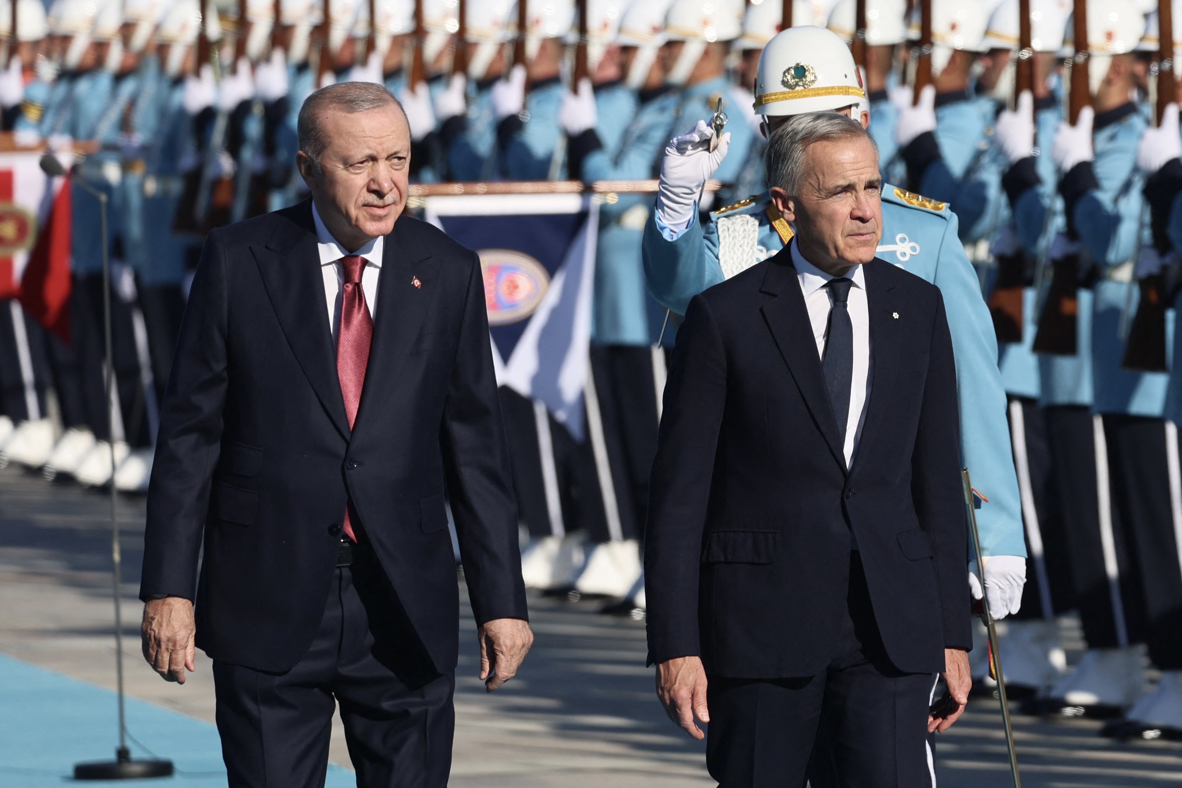 Turkish President Recep Tayyip Erdogan (L) welcomes Canadian Prime Minister Mark Carney (R) during an official ceremony at the Presidential Complex during his official visit to Turkey, in Ankara on October 22, 2026. (Photo by Adem ALTAN / AFP)